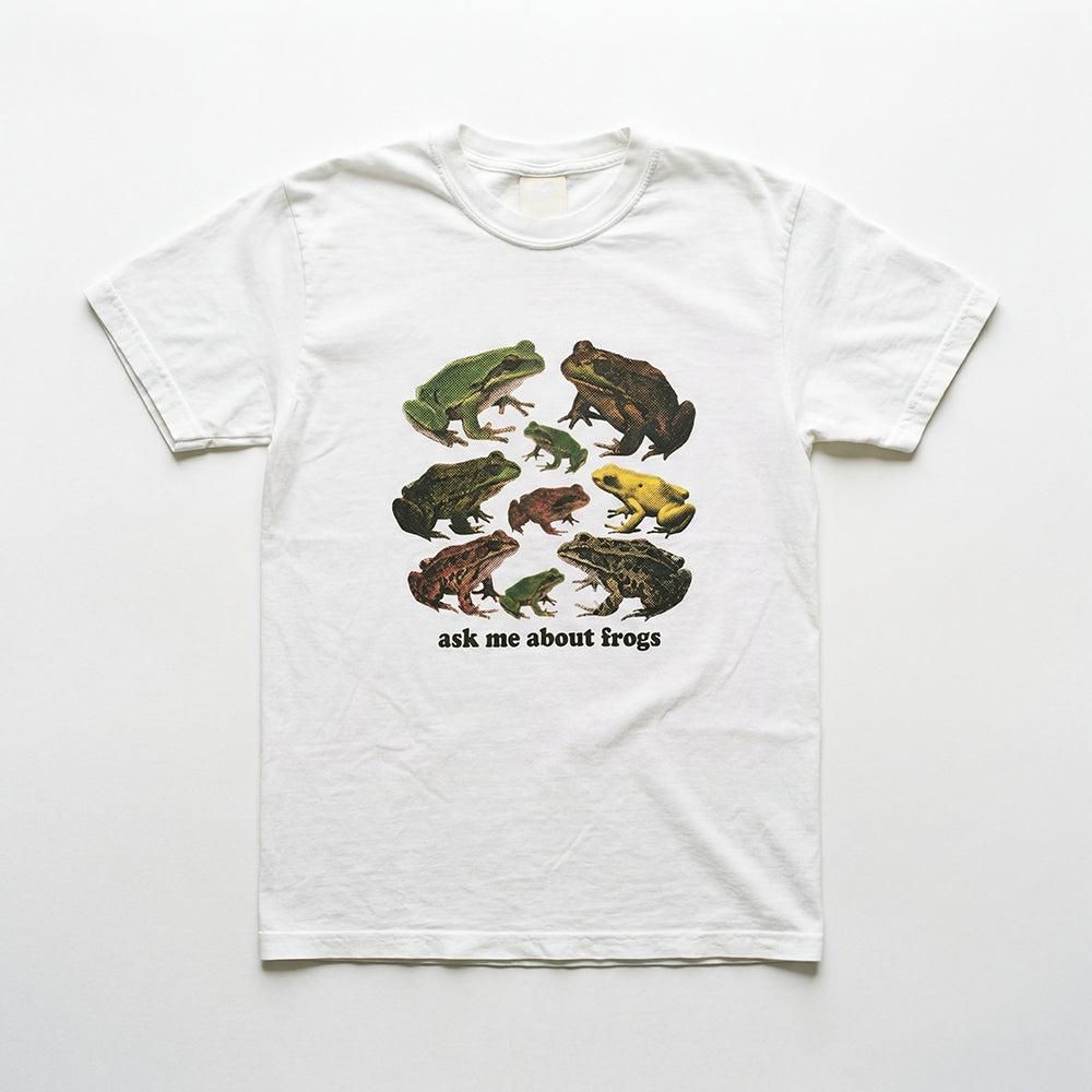 A white tshirt with a bunch of frogs on it. It says ask me about frogs.