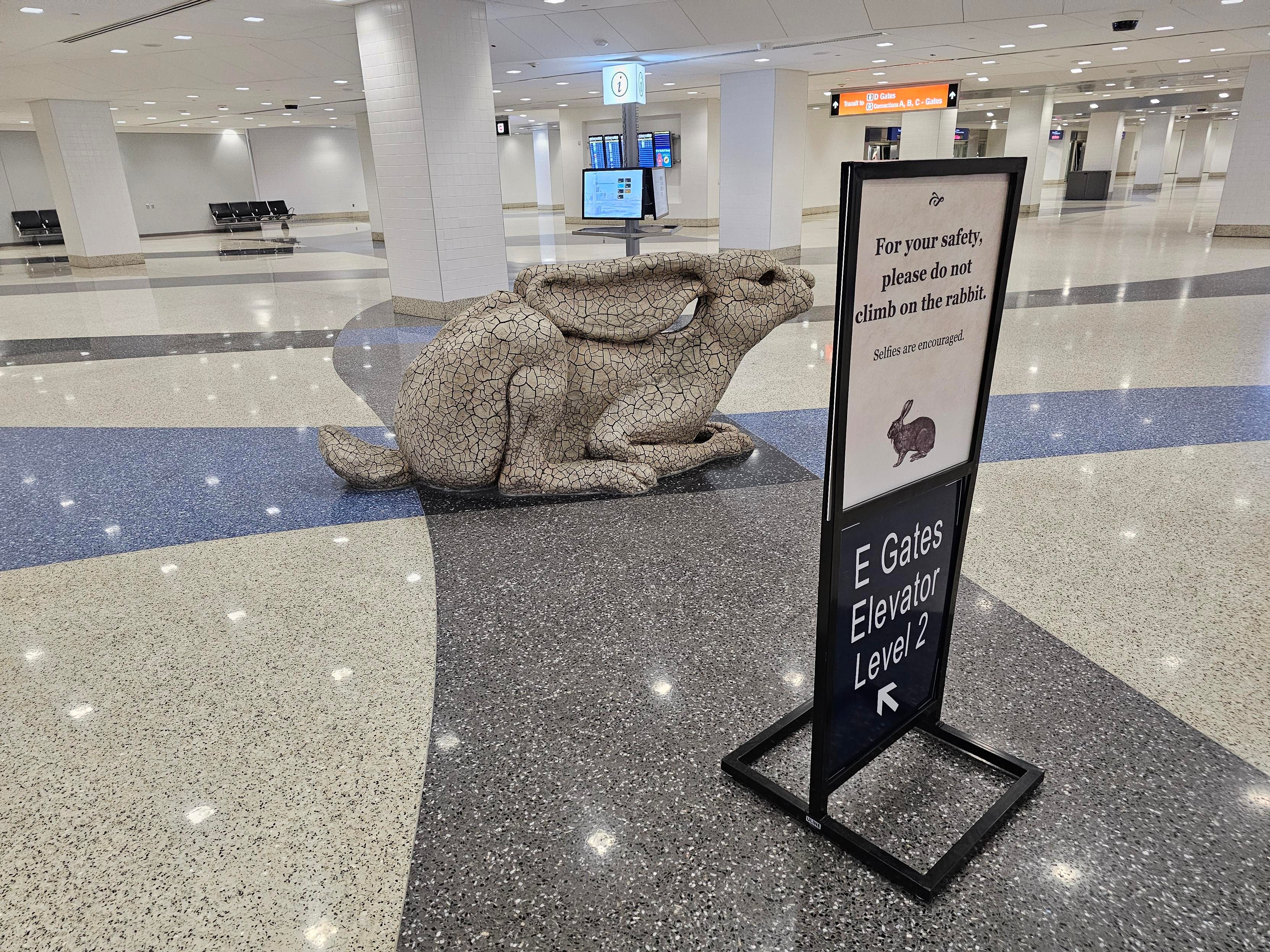 A statue of a rabbit in the middle of the Harry Reid airport
