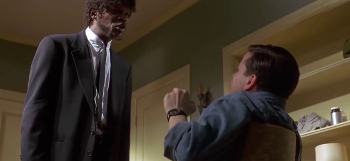 Picture of Jules Winnfield from Pulp Fiction, asking a guy in chair if they use alt text in "What"
