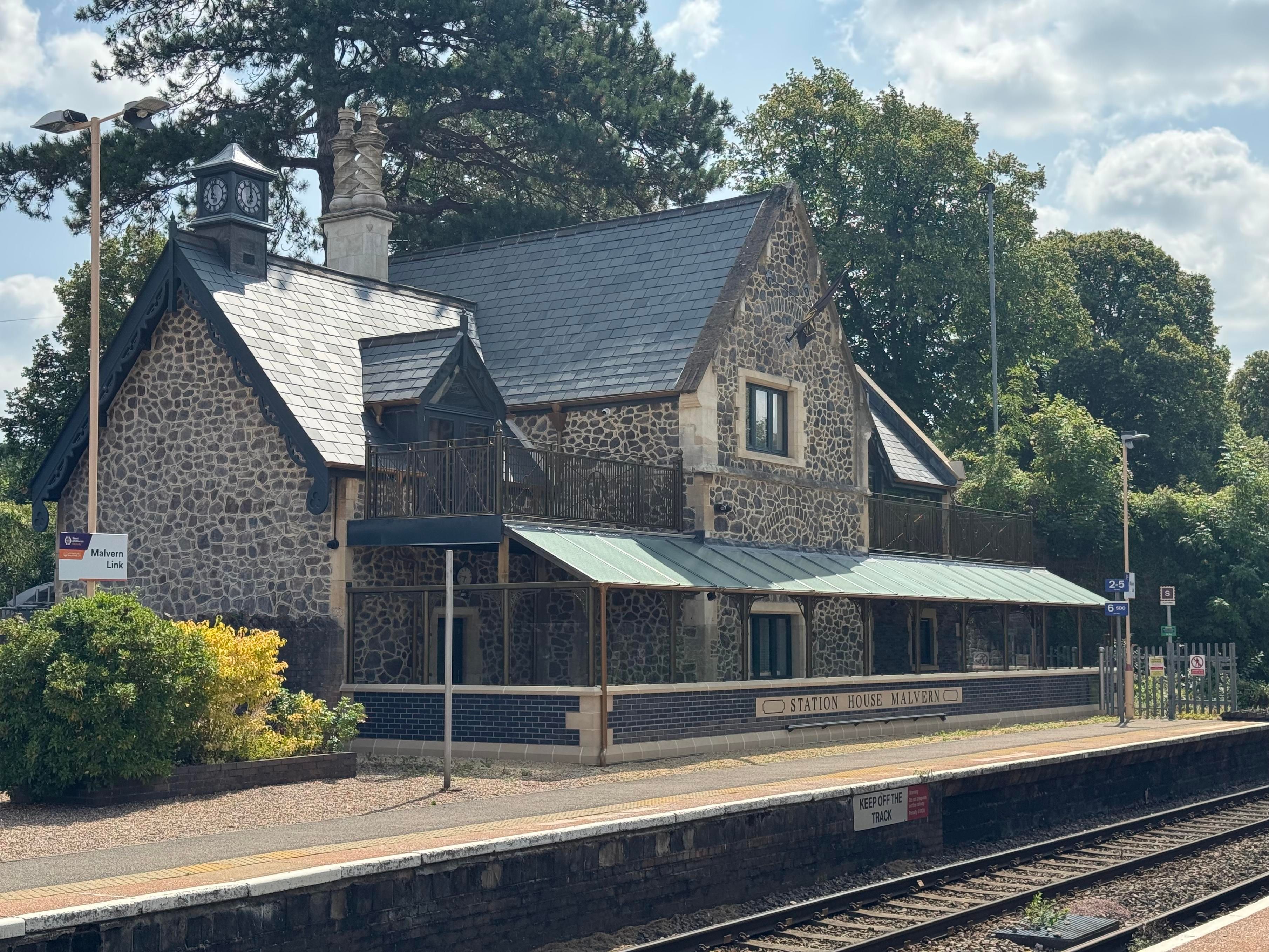 Station House Malvern, a very pretty recently restored station building abutting the platform, that is going to be an Airbnb. It has some pretty details on the spiral chimneys, a steam-train-shaped weather vane, and a clock that is stopped at 12:00. 