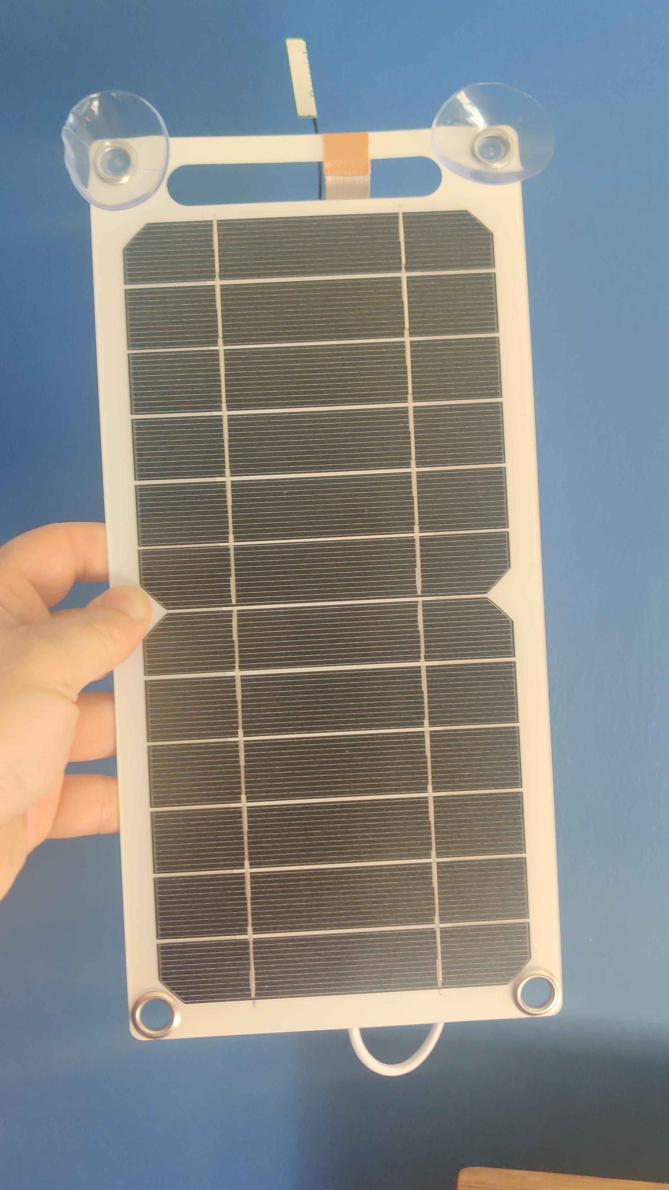 The front of the solar panel. The world's least good antenna can be seen poking from the top. There are suction cups to allow it to be attached to a window.