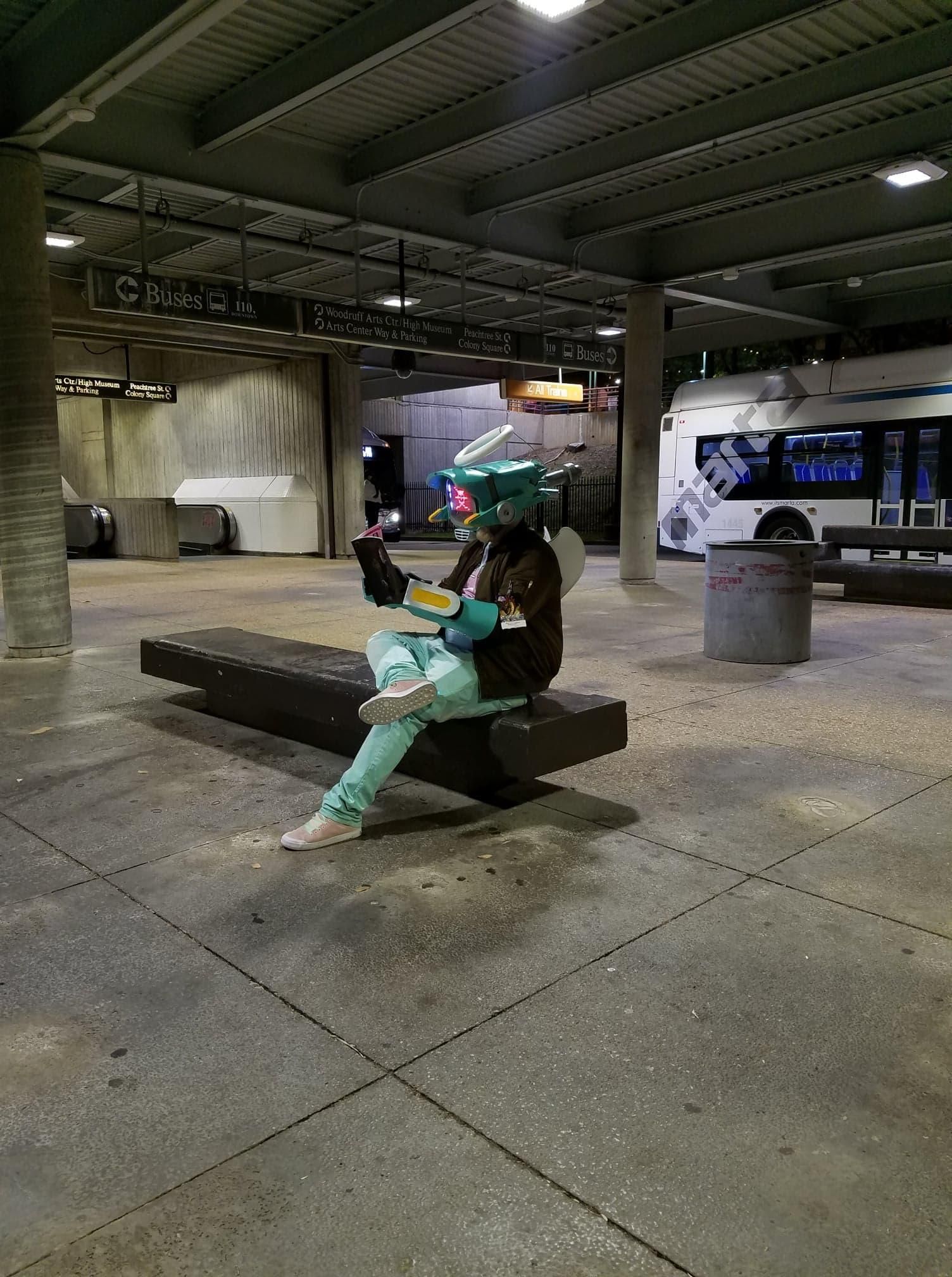 Me in full cosplay reading a magazine in a bus station.