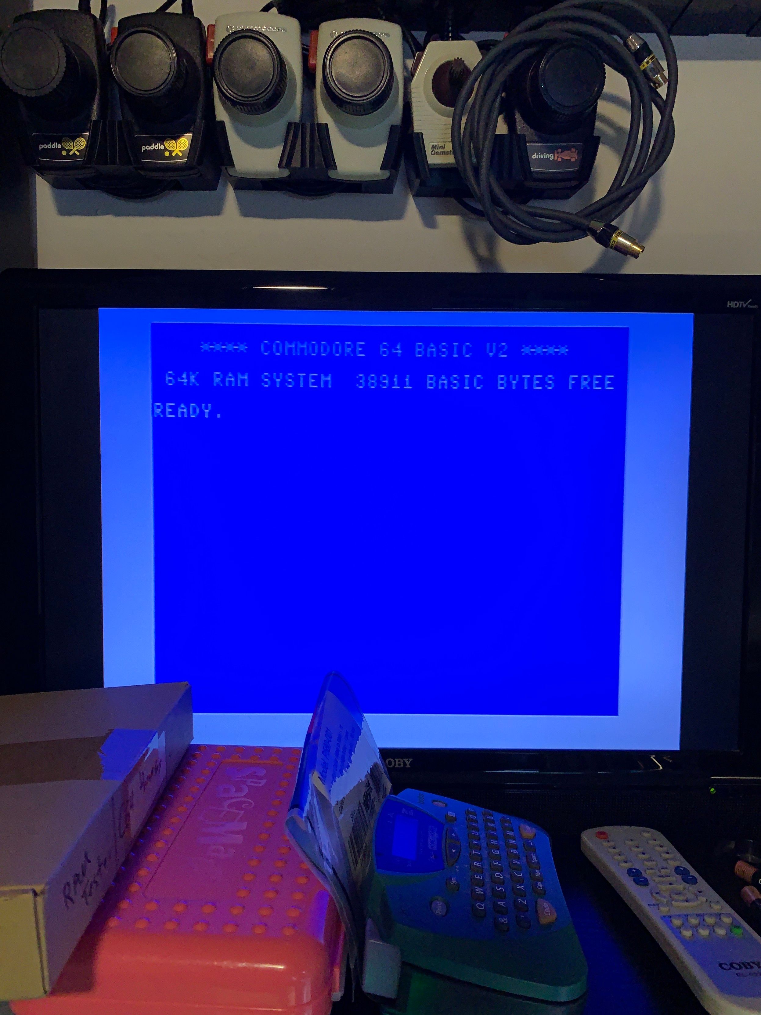 Standard C64 READY screen in BASIC after the ROM was resoldered.  White border on blue screen with white text “Commodore 64 basic v2 64k ram 38911 basic bytes free READY”.  

The white blinking cursor waits for commands.