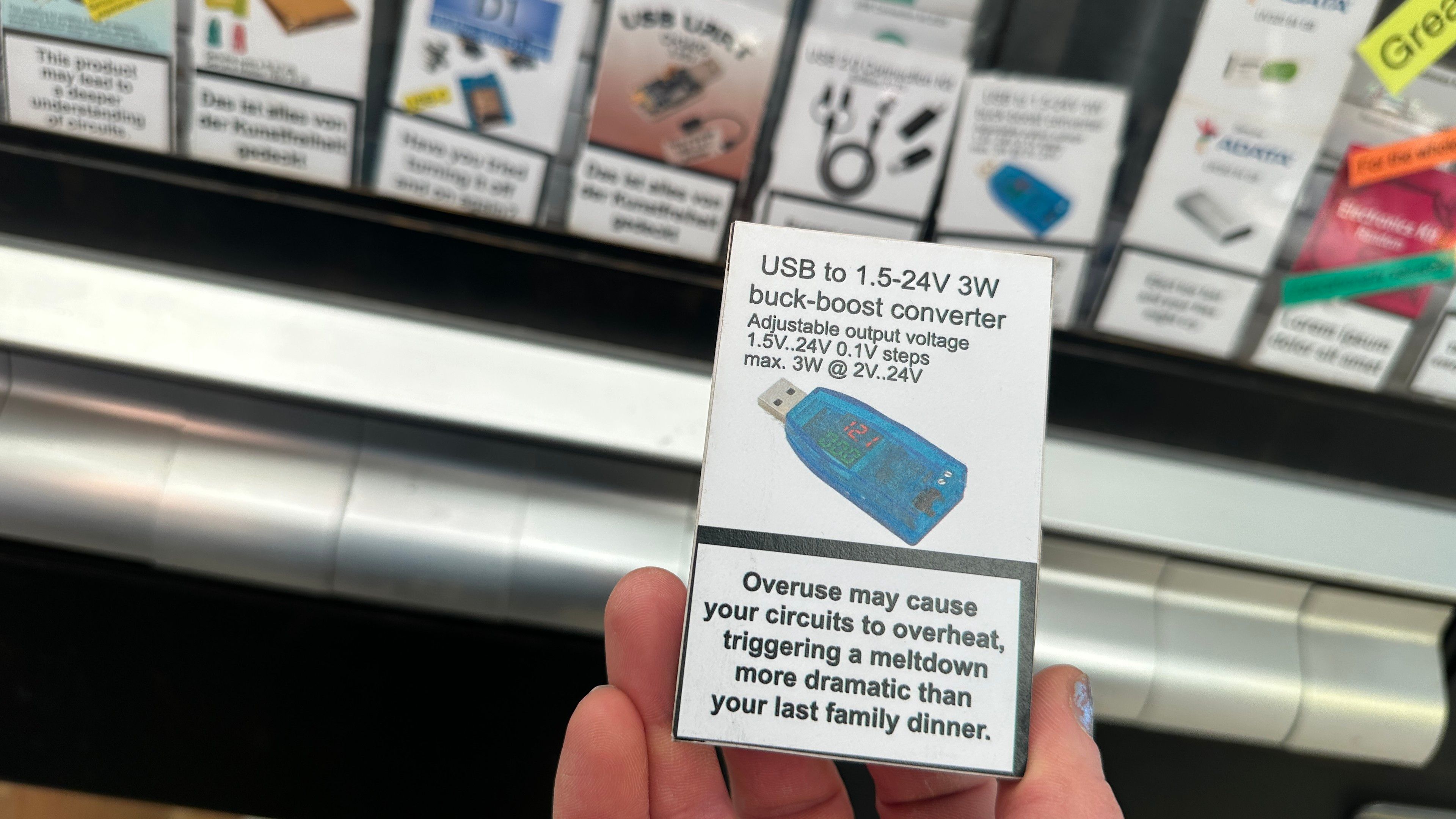 Electronics packages in a cigarette vending machine. The warning sticker says overuse may cause your circuits to overheat triggering a meltdown more dramatic than your last family dinner. 