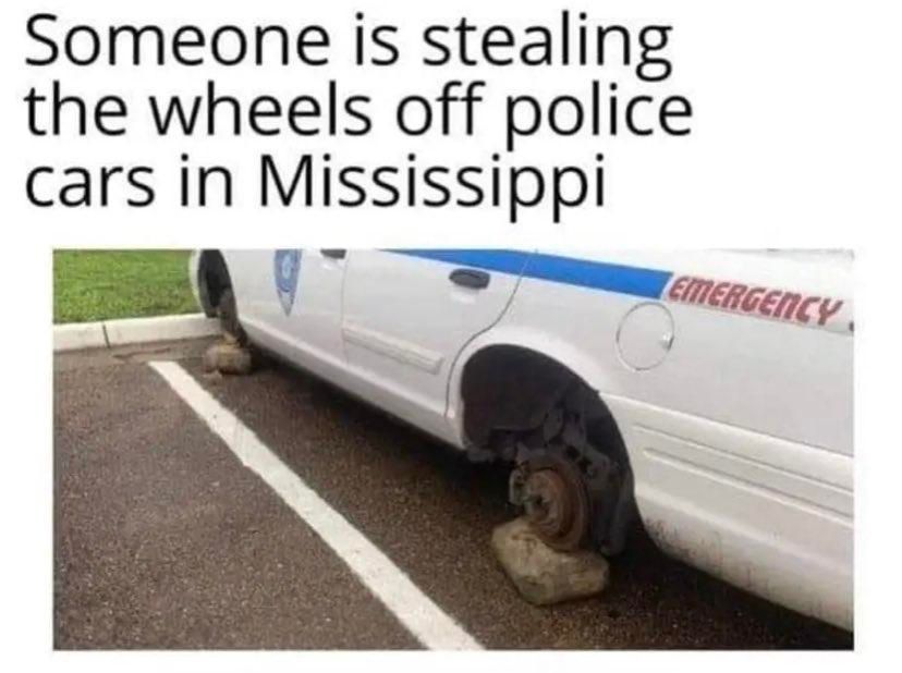 Someone is stealing the wheels off police cars in Mississippi (picture of police car with no wheels, being propped up by rocks)