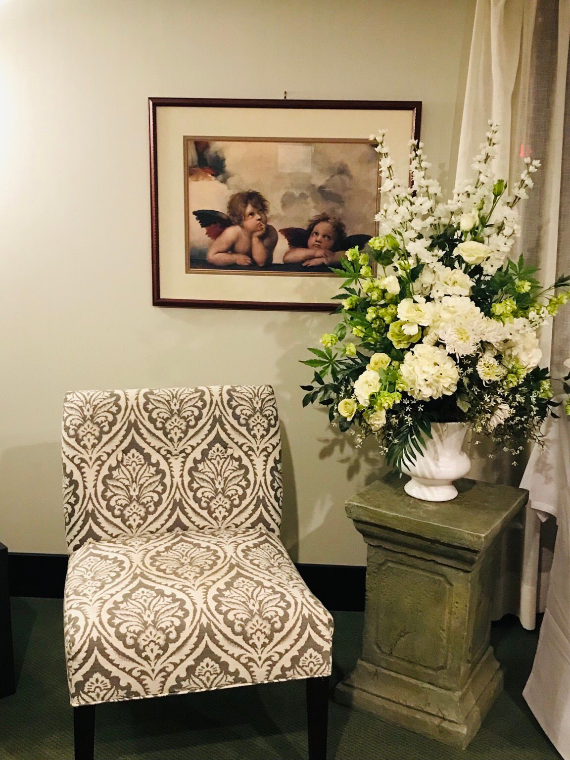 At my grandma’s private viewing. Angels and flowers