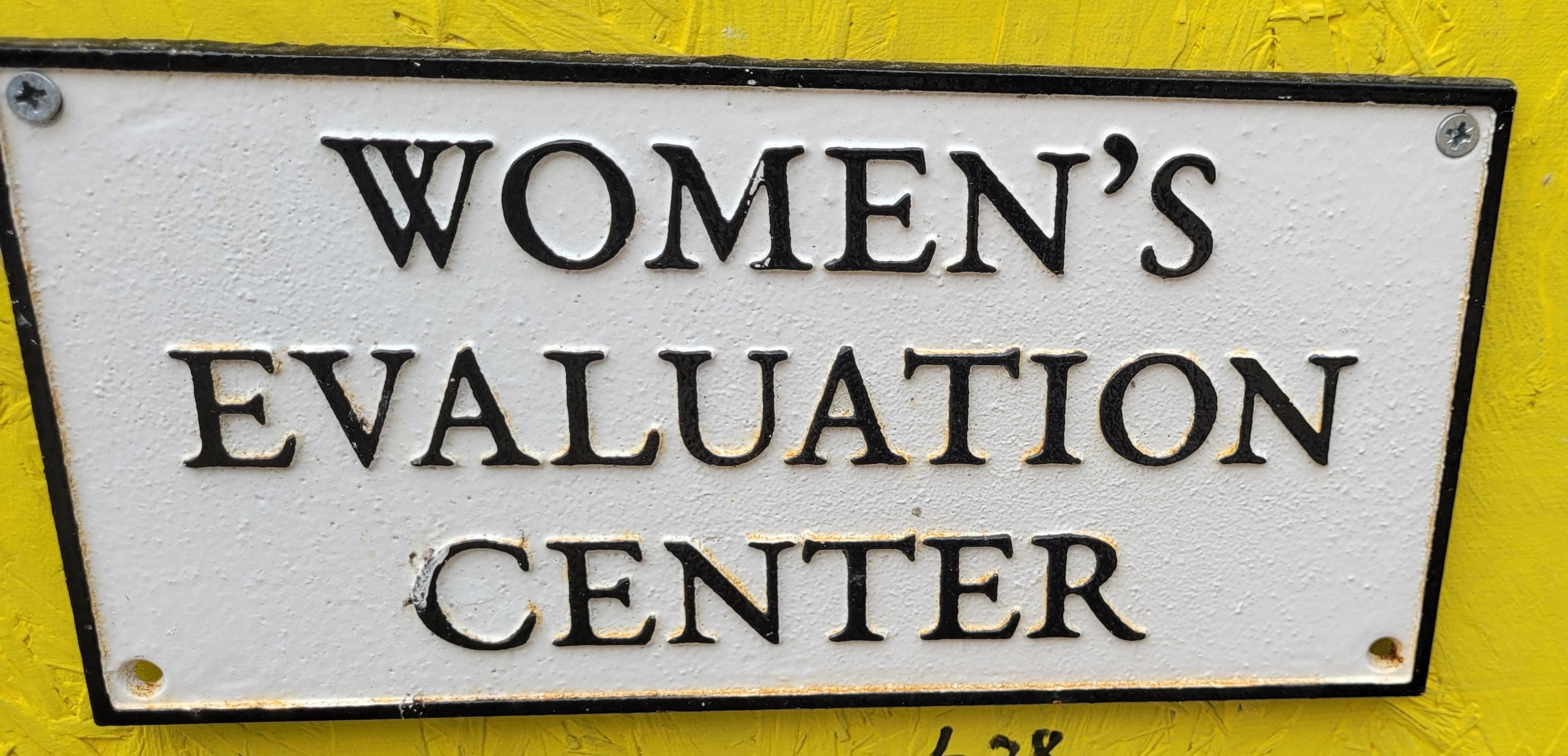 WOMEN'S
EVALUATION
CENTER

(sign black writing on white, against a pretty yellow wall) 