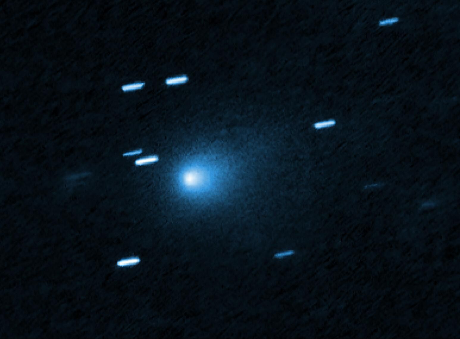 This is a Hubble Space telescope image of the interstellar comet 3I/ATLAS. Hubble photographed the comet on 21 July 21 2025, when the comet was 365 million kilometres from Earth. Hubble shows that the comet has a teardrop-shaped cocoon of dust coming off its solid, icy nucleus. Because Hubble was tracking the comet moving along a hyperbolic trajectory, the stationary background stars are streaked in the exposure.

[Image description: At the center of the image is a comet that appears as a teardrop-shaped bluish cocoon of dust coming off the comet’s solid, icy nucleus and seen against a black background. The comet appears to be heading to the bottom left corner of the image. About a dozen short, light blue diagonal streaks are seen scattered across the image, which are from background stars that appeared to move during the exposure because the telescope was tracking the moving comet.]

Credit: NASA, ESA, D. Jewitt (UCLA); Image Processing: J. DePasquale (STScI)