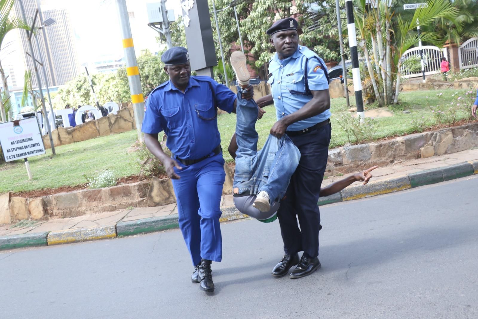 Julius Kamau was dragged by two police officers after protesting against war in Sudan and Congo. 