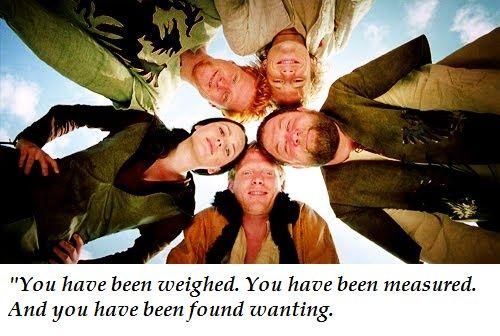 A screenshot from A Knight's Tale. The main cast is standing together, viewed from directly below. The caption is their ensemble dialogue from this scene, where they are telling Count Ademar, "You have been weighed, you have been measured, and you have been found wanting."