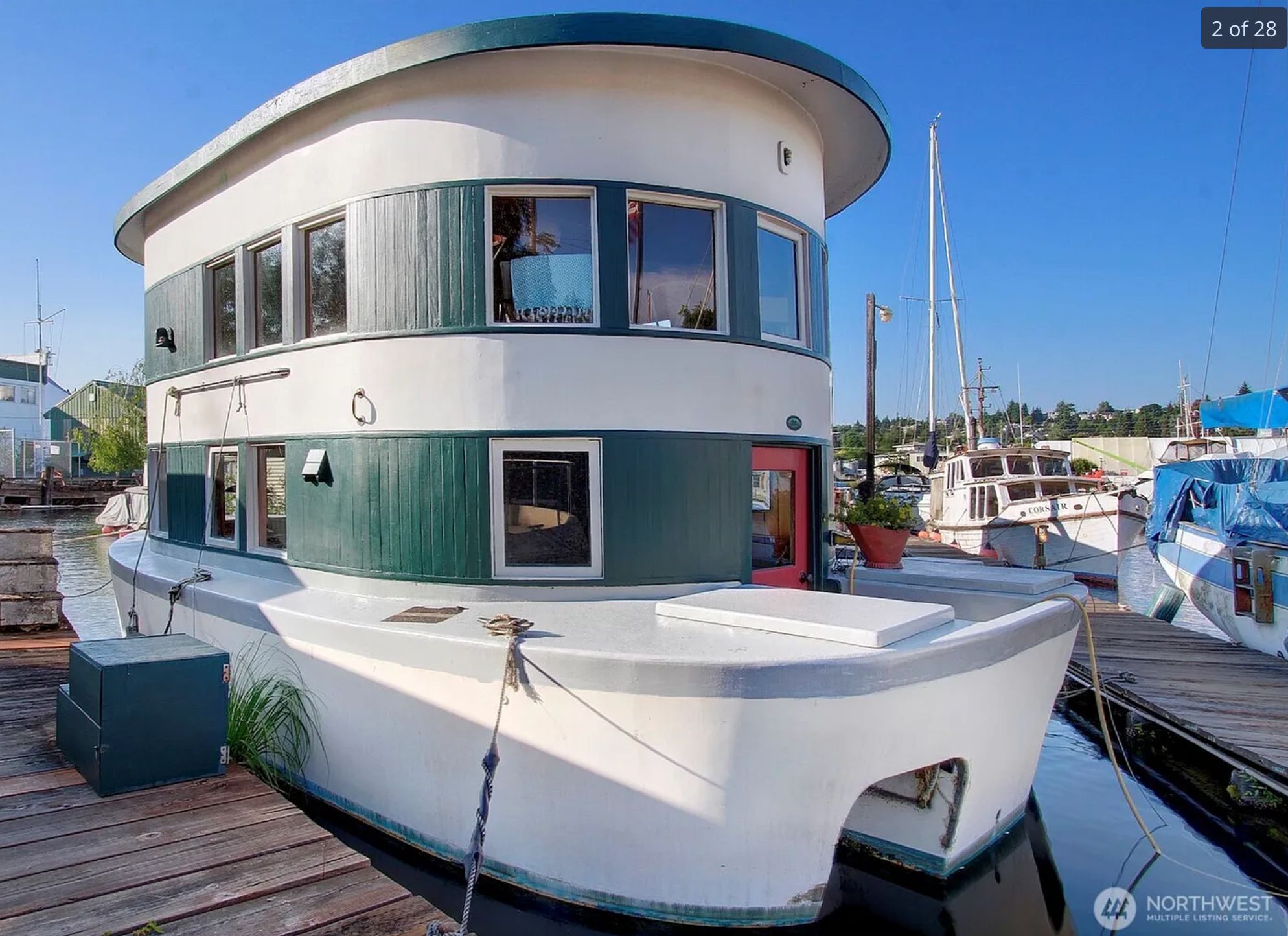 A boat with a 2 story house structure on it, oval and tall with 2 stories. The overall impression is of some kind of tugboat house. 