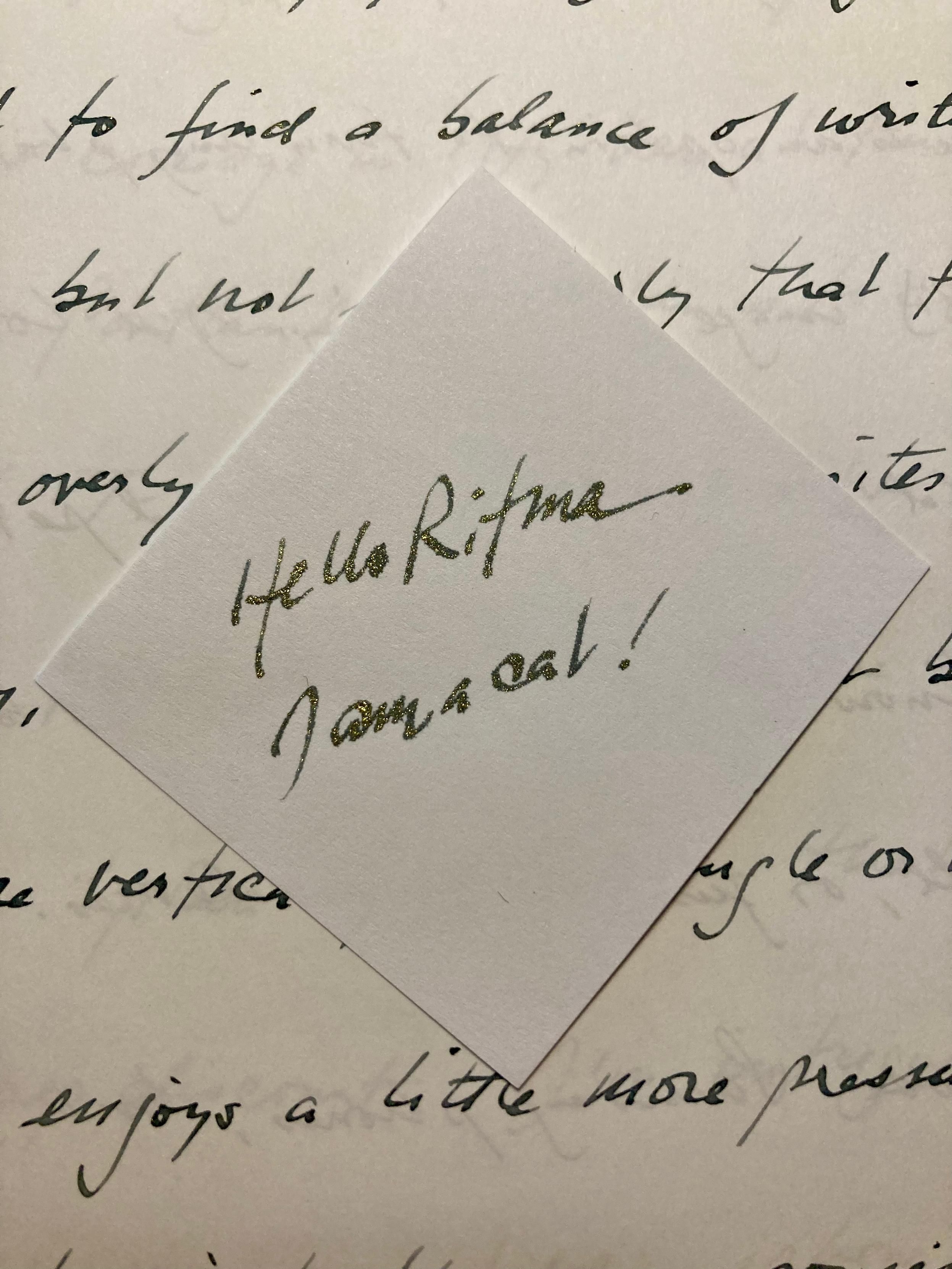 This photo shows handwriting on two types of paper. In the center of the page the ink's tiny metallic flakes can be seem to shimmer, but in the background the same ink on different paper shows little shimmer effect. 