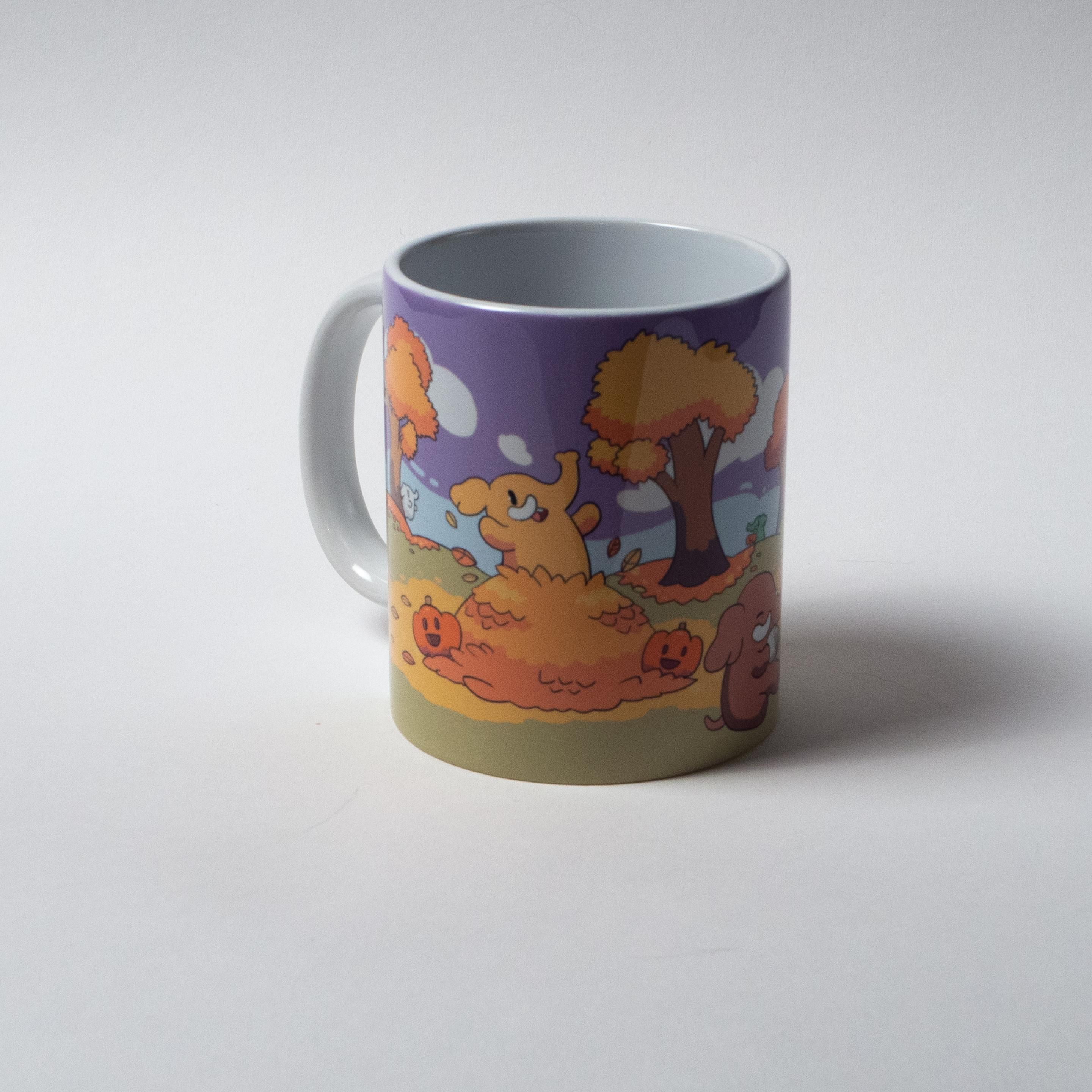 The same mug from a different angle, in which you can see a Mastodon emerging from a pile of leaves, as well as some happy pumpkins.
