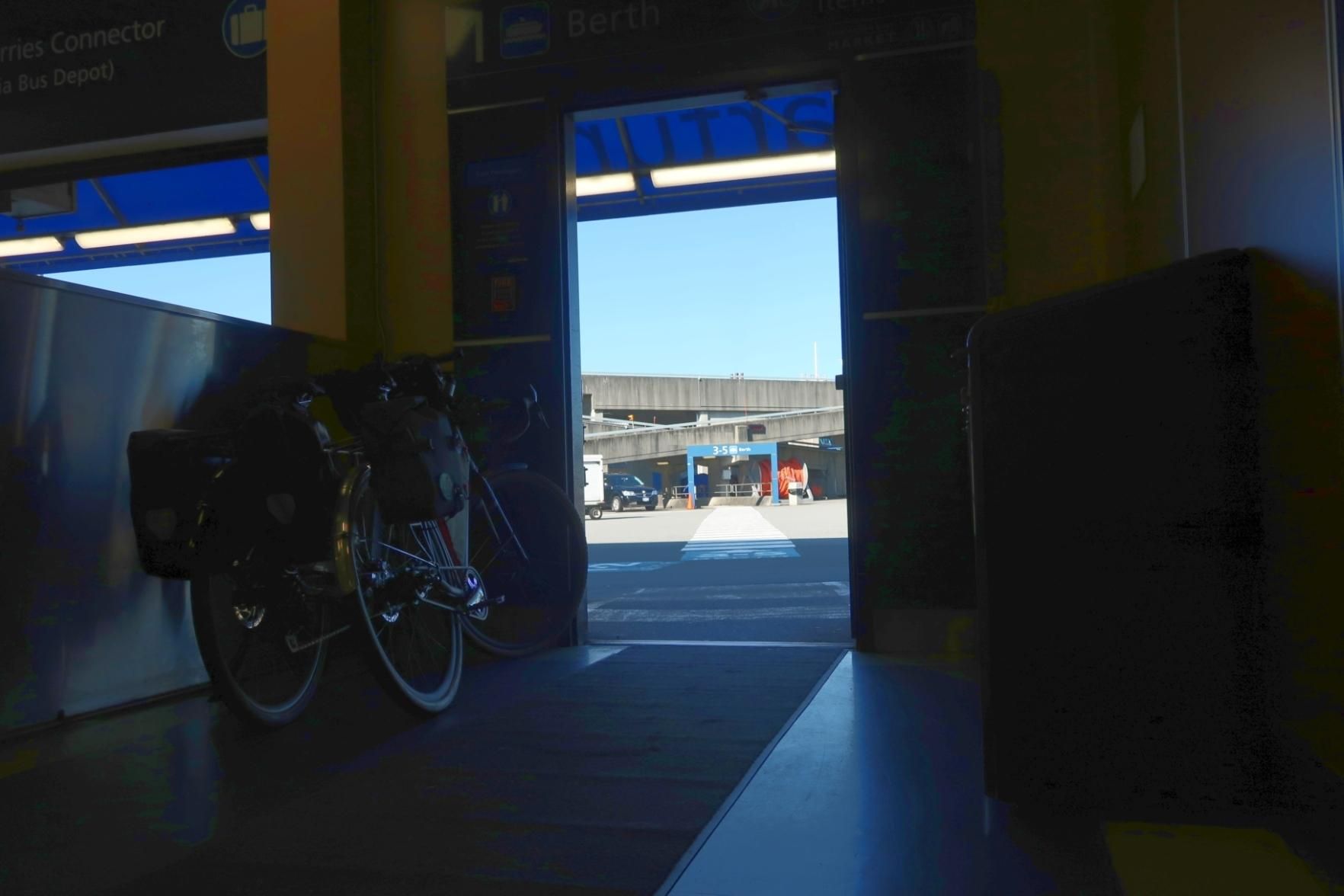 2 bicycles with bags in a hallway of a ferry terminal