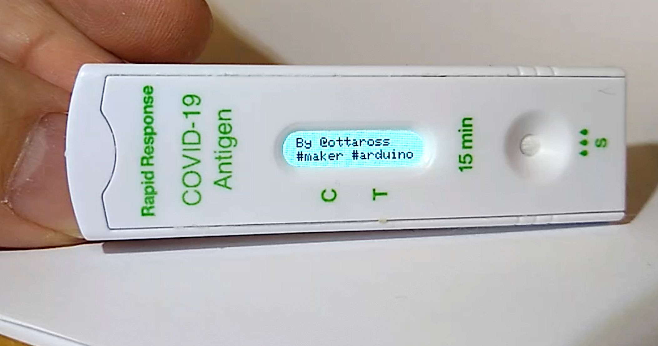 A closeup of the test device with some tiny text on the screen indicating my @ottaross handle and hashtags for makers and arduino fans