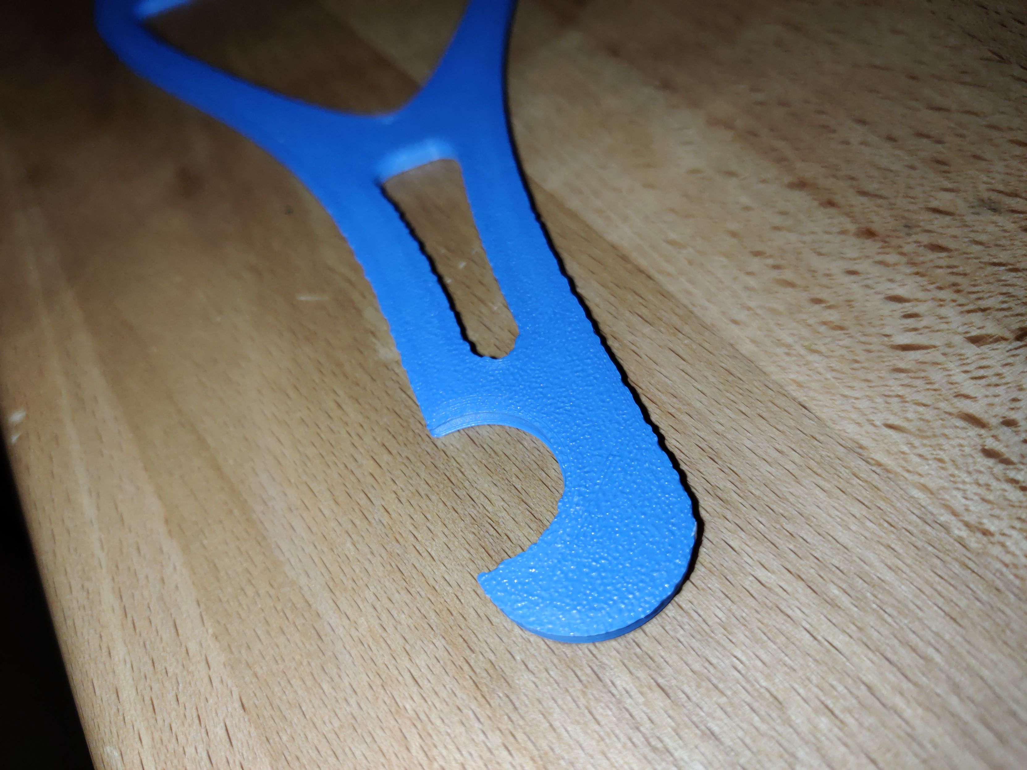 3D printed object's underside on the left: there's a distinct "bumpy" texture to it, however the outlines are rough. The plastic was squeezed through the textured build plate because the nozzle was too low, causing the corners of the object to not be a straight line. Also obviously a too low nozzle night crash into the build plate, which fortunately did not happen here.