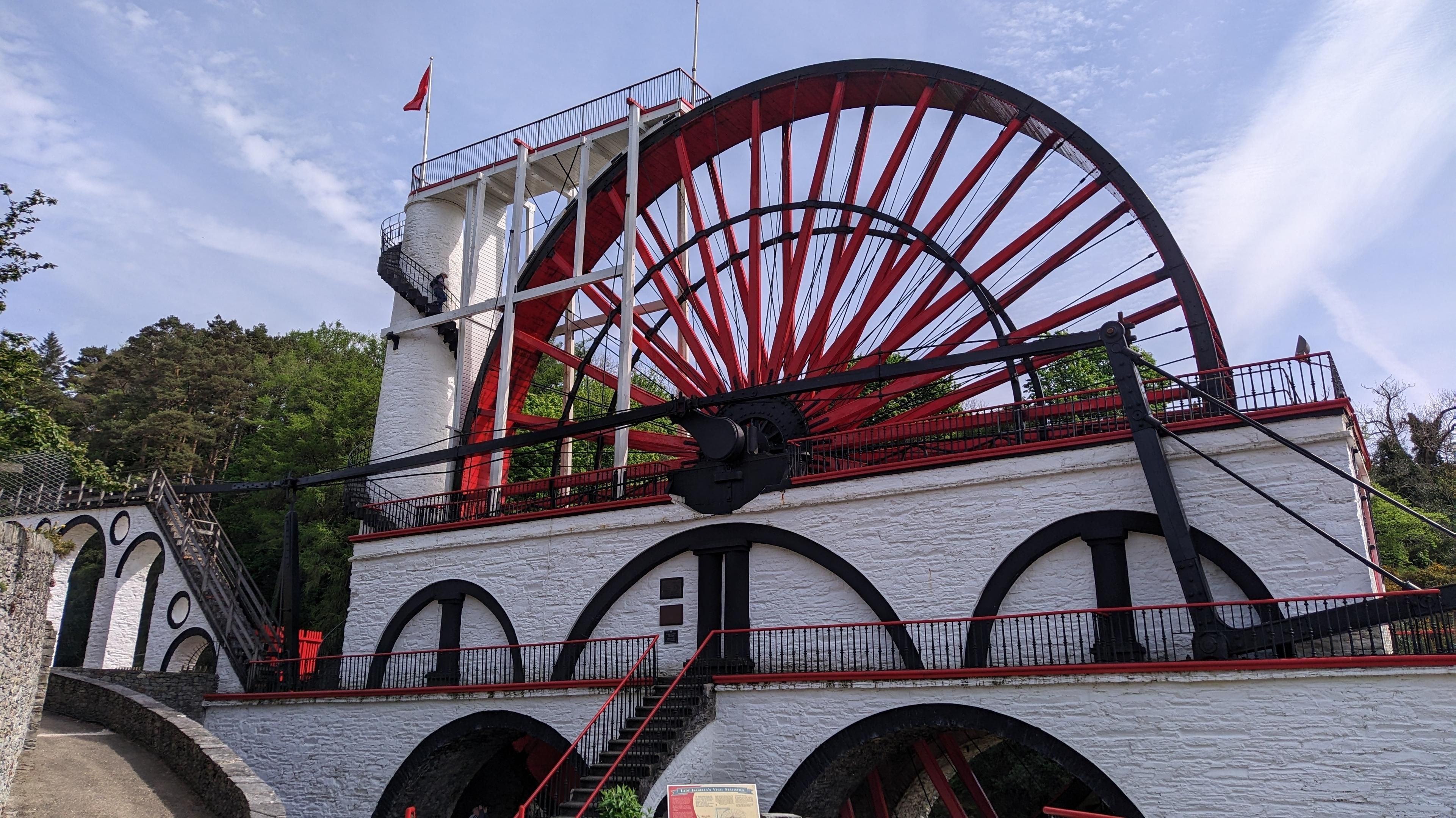 Large red-black whater wheel with encased in white stone