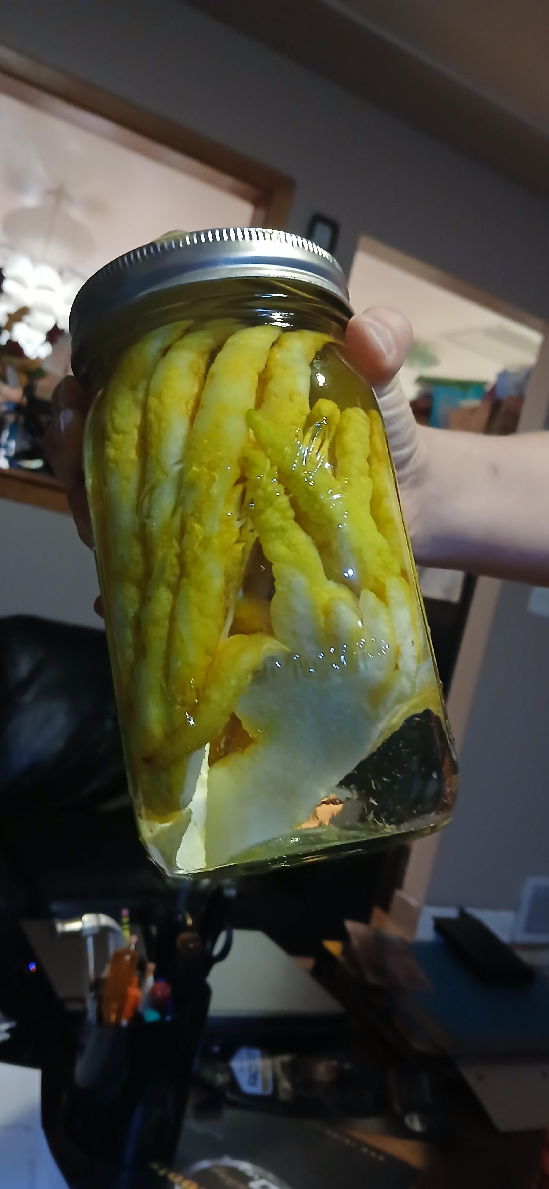 Somewhat cut up Buddha's hand in a 1.5 liter jar