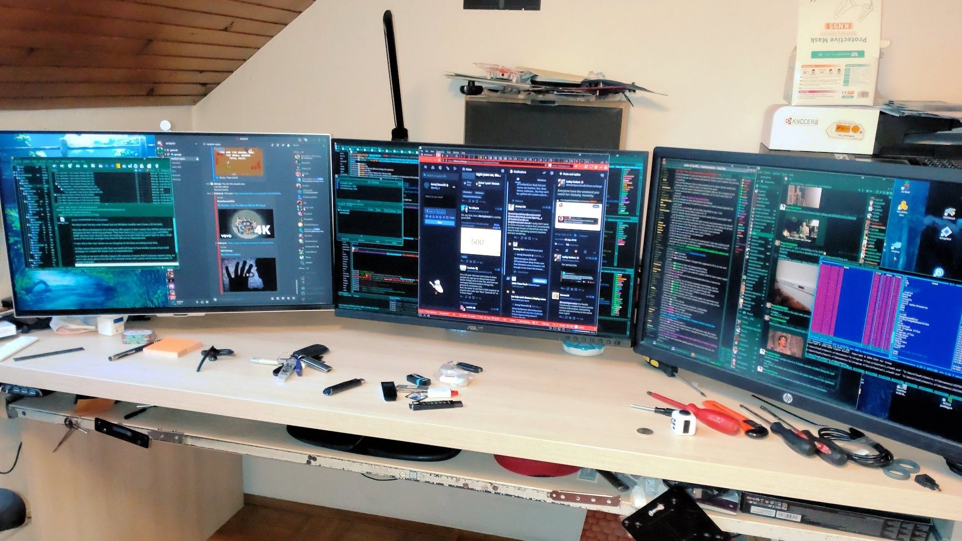 Desk with 3 monitors.