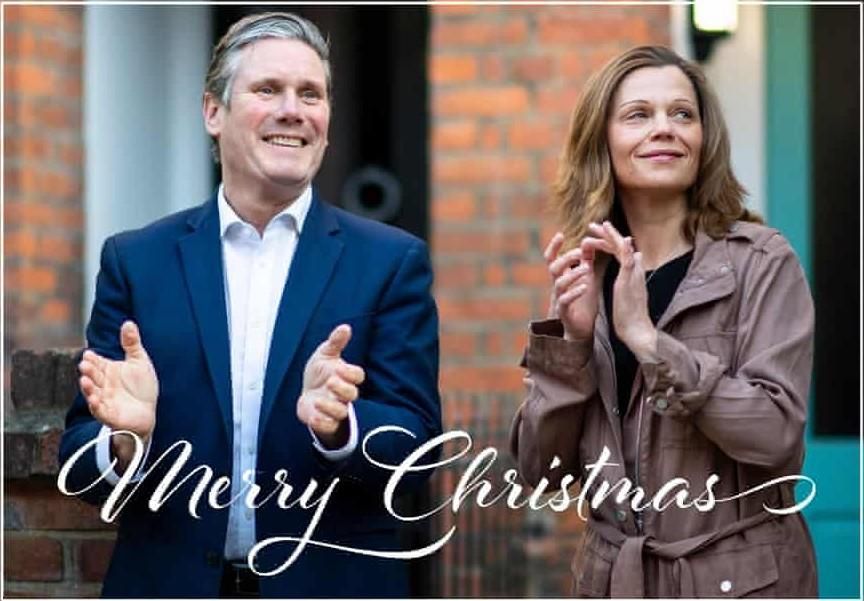 Kier Starmer and wife (he is really punching) clapping for some reason (I assume the NHS or free clothes or possibly for Reform). He has blue suit and light blue shirt (no tie) and she is wearing a detective coat and is fit. He has a face that doesn't seem natural to smile. He has a face that suggests wasted potential. The face of a person who squandered the opportunity of a lifetime. She has the face of someone who wants out of that life and to have a brief but wild fling with some ordinary guy off the streets. Perhaps also with a massive amount of wasted potential. Perhaps the sort of person who fills his days writing stupid shit on the Internet. 