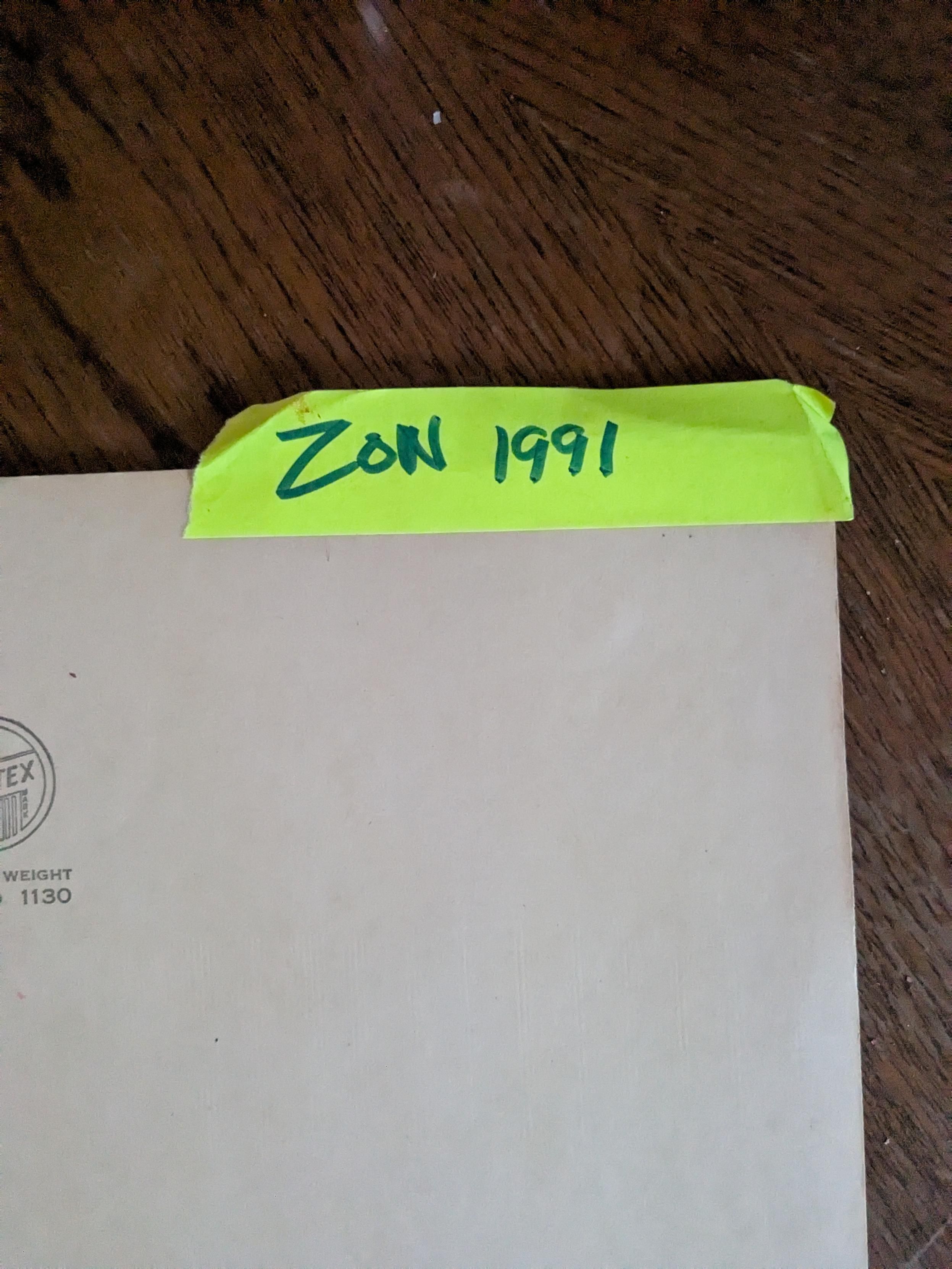 A folder with a sticker that says ZON 1991