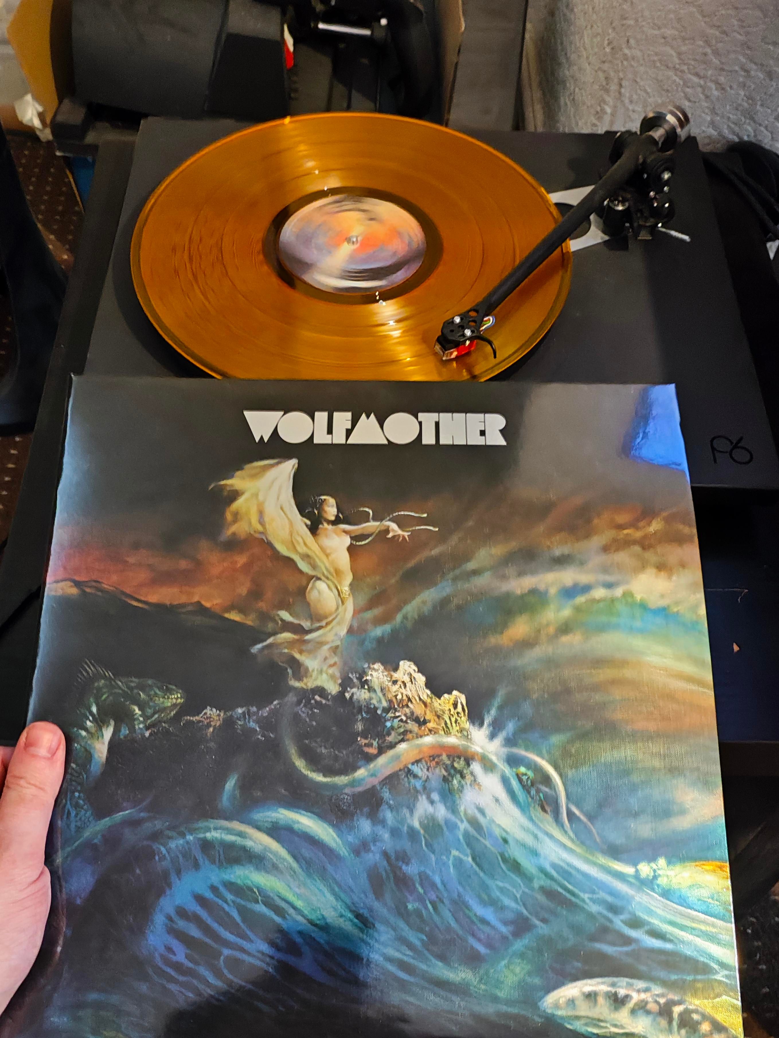 A surpent over a rough sea vinyl artwork and orange vinyl 