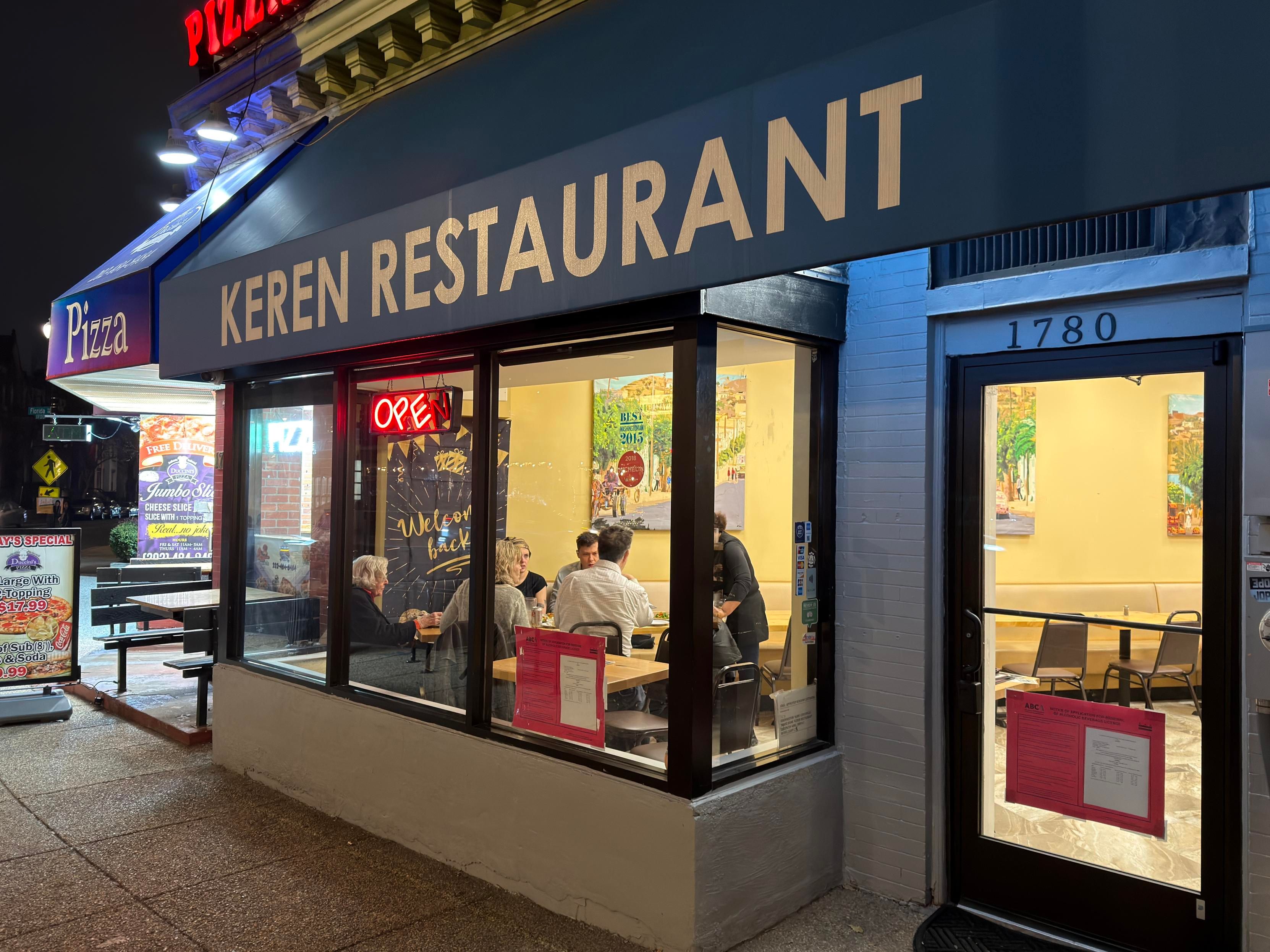AN OPEB restaurant in an urban storefront with an awning reading KEREN RESTAURANT 