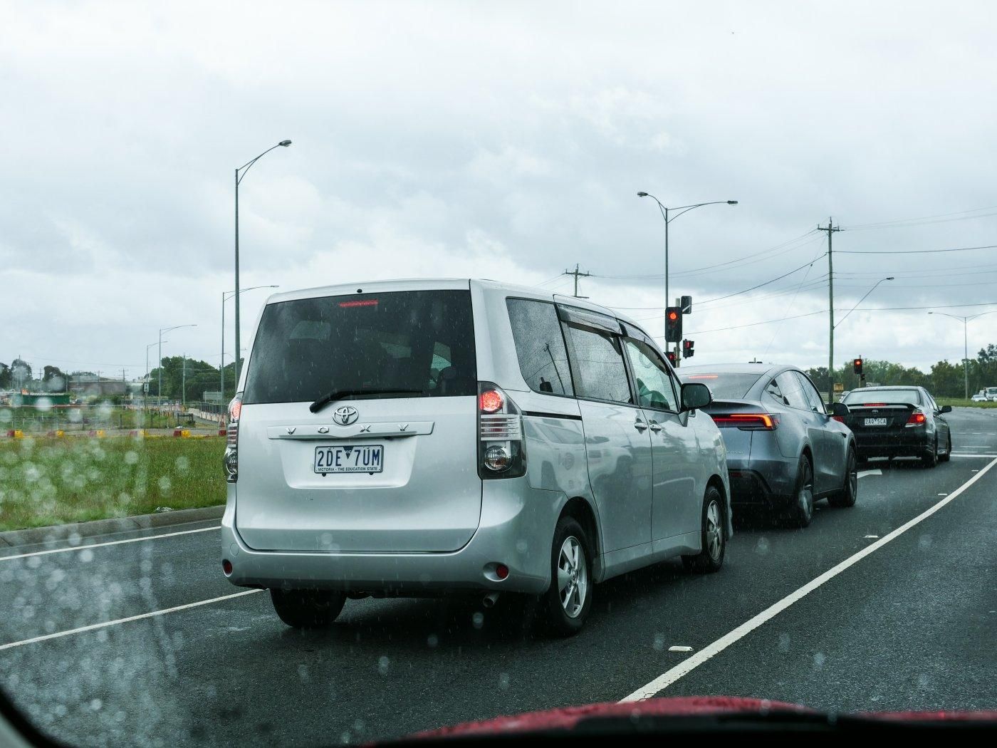 Silver Toyota Voxy van, a narrow MPV. 