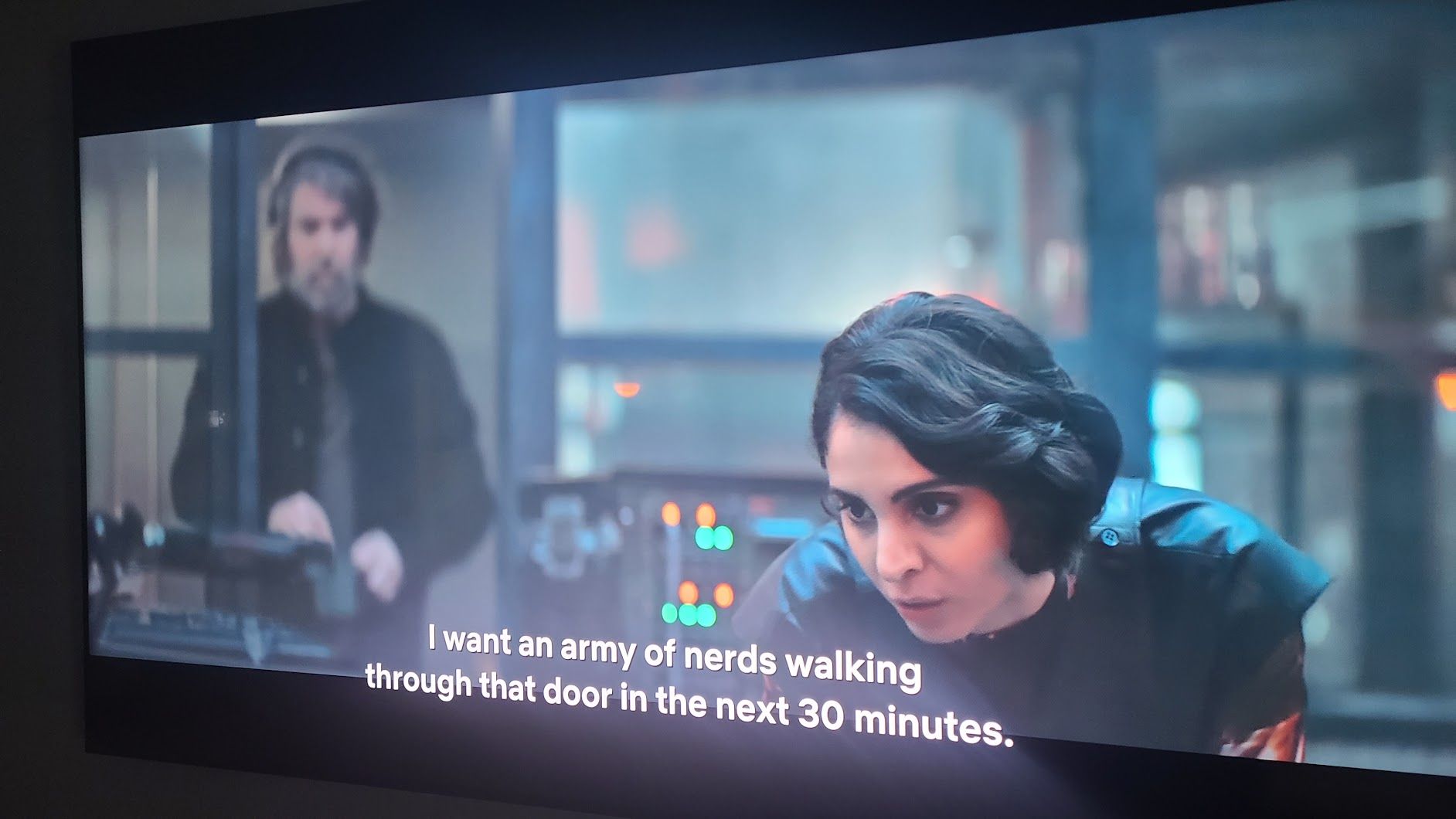 Screenshot of a TV show displaying two characters with subtitles that read "I want an army of nerds walking through that door in the next 30 minutes."