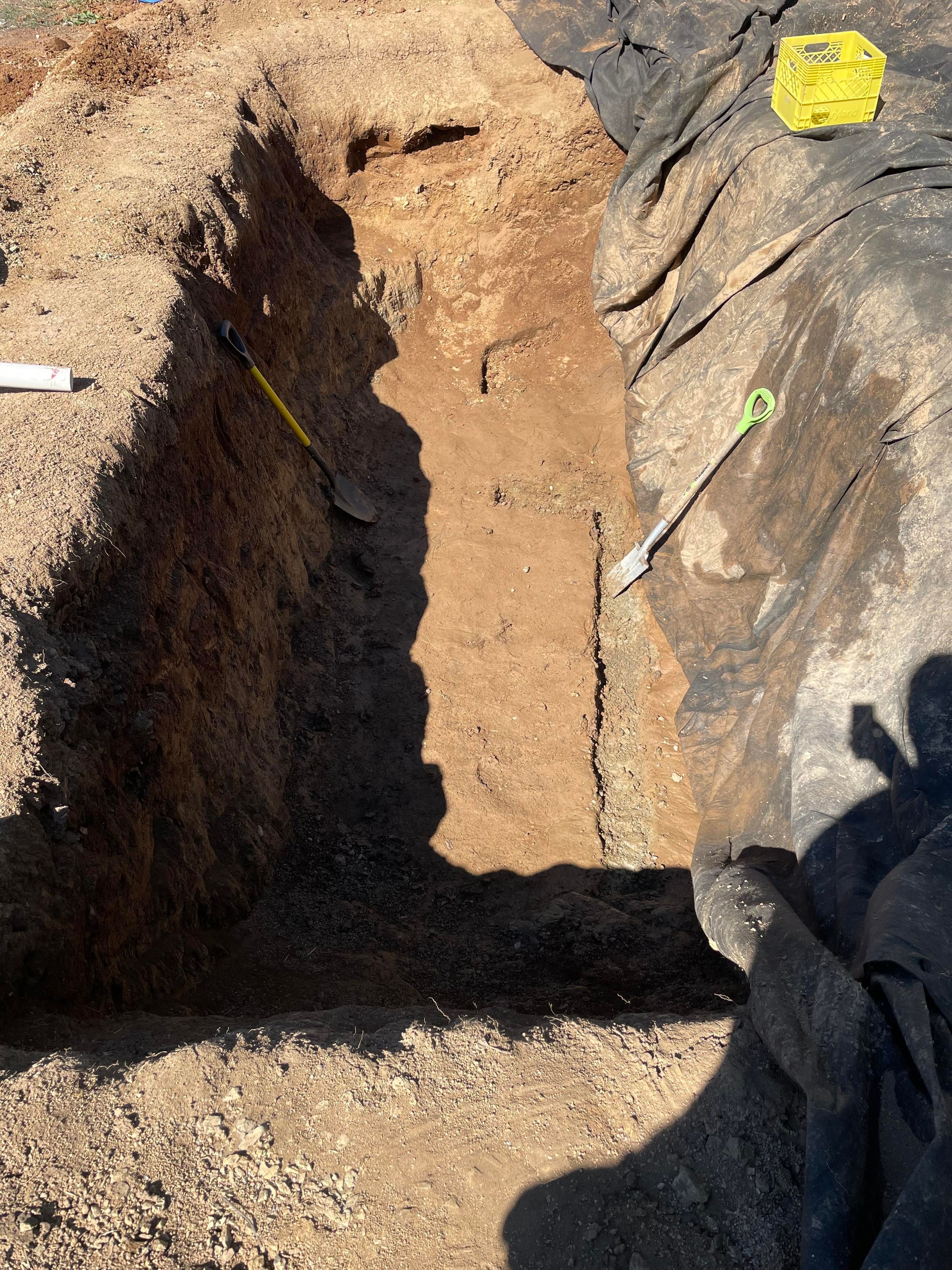 A view down into the pit shows the trench taking shape. It is, of course, in the sunlight while the non-trenched side is in the shade. Such as life.