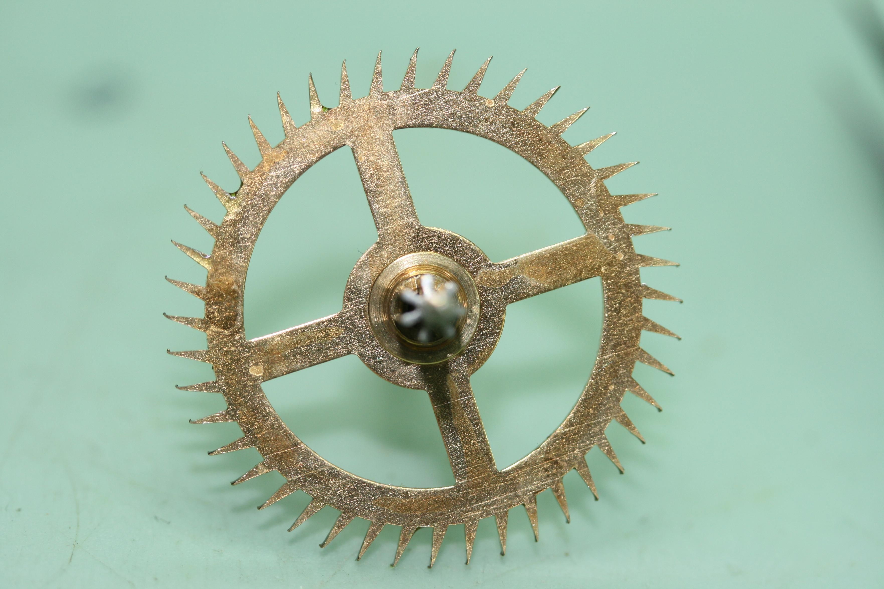 A clock escape wheel with about 40 teeth, the tips of the teeth are slightly bent at the tip
