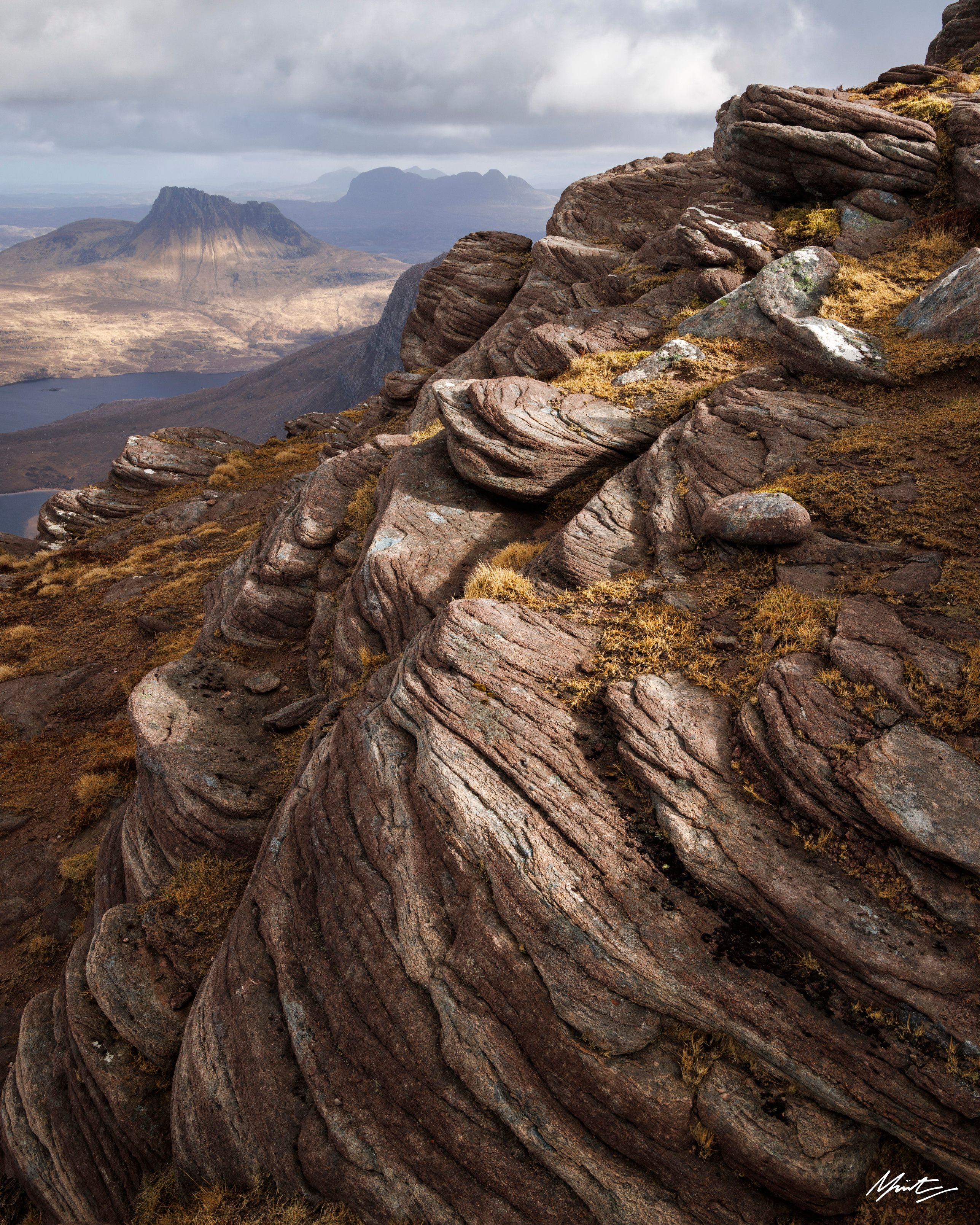 dappled light over the scottish moors with torridonian sandstone in the foreground