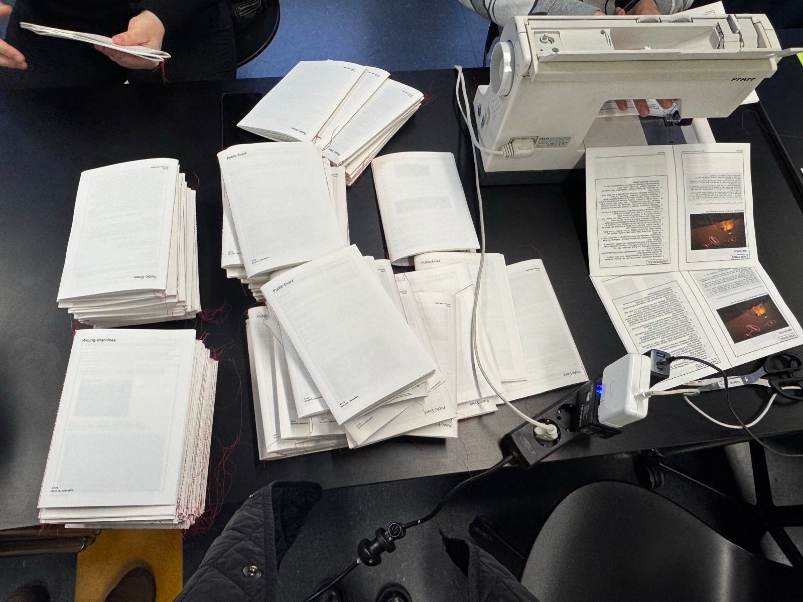 Sewing machine being used to bind the fold.