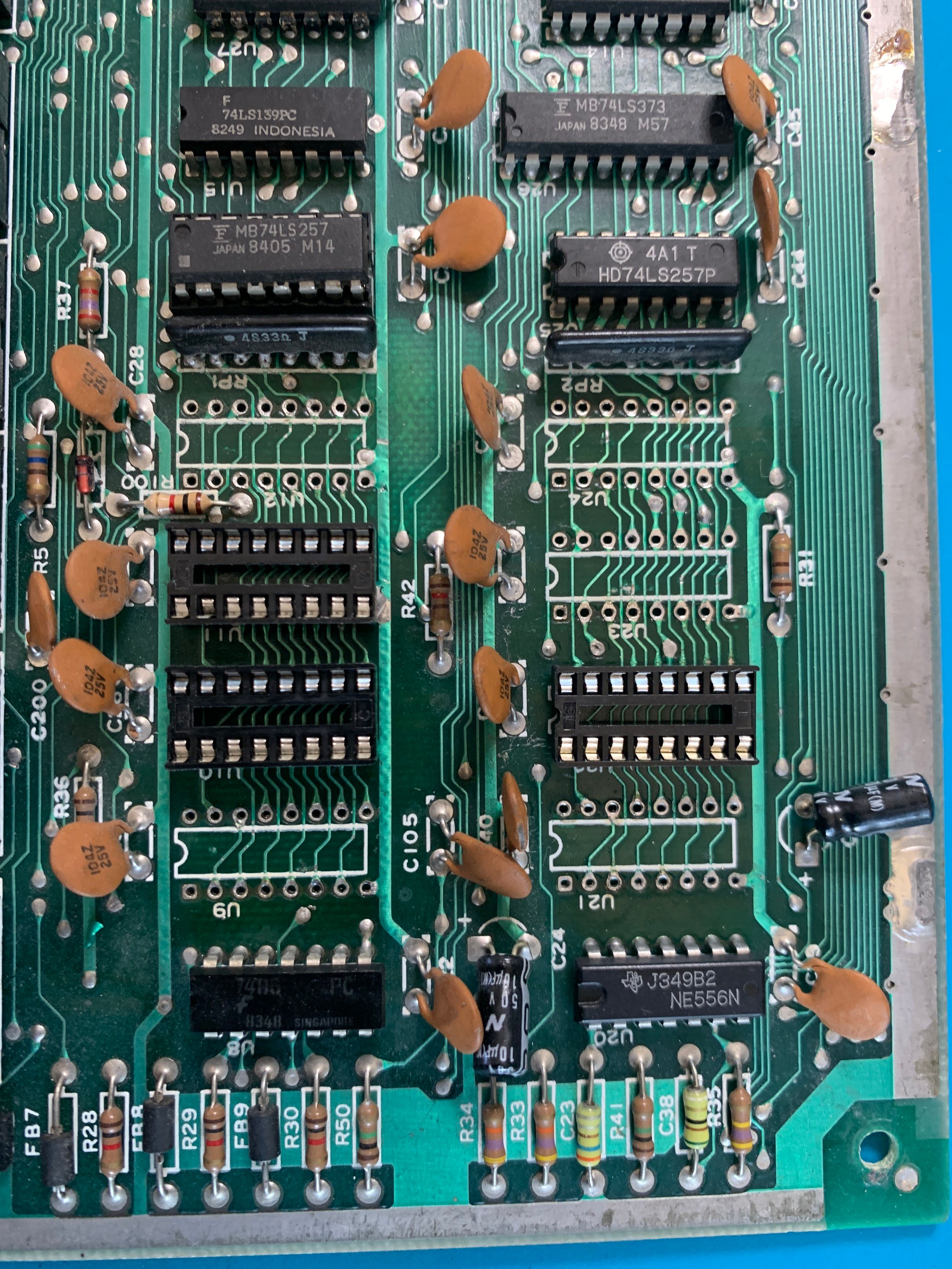 Test fit of sockets in the main board.  Only 3 sockets cleanly seat into the sockets (U22, U10 and U11).  The other 5 need to have one or two holes tidied up.  Green solder mask board with black sockets and integrated circuits.