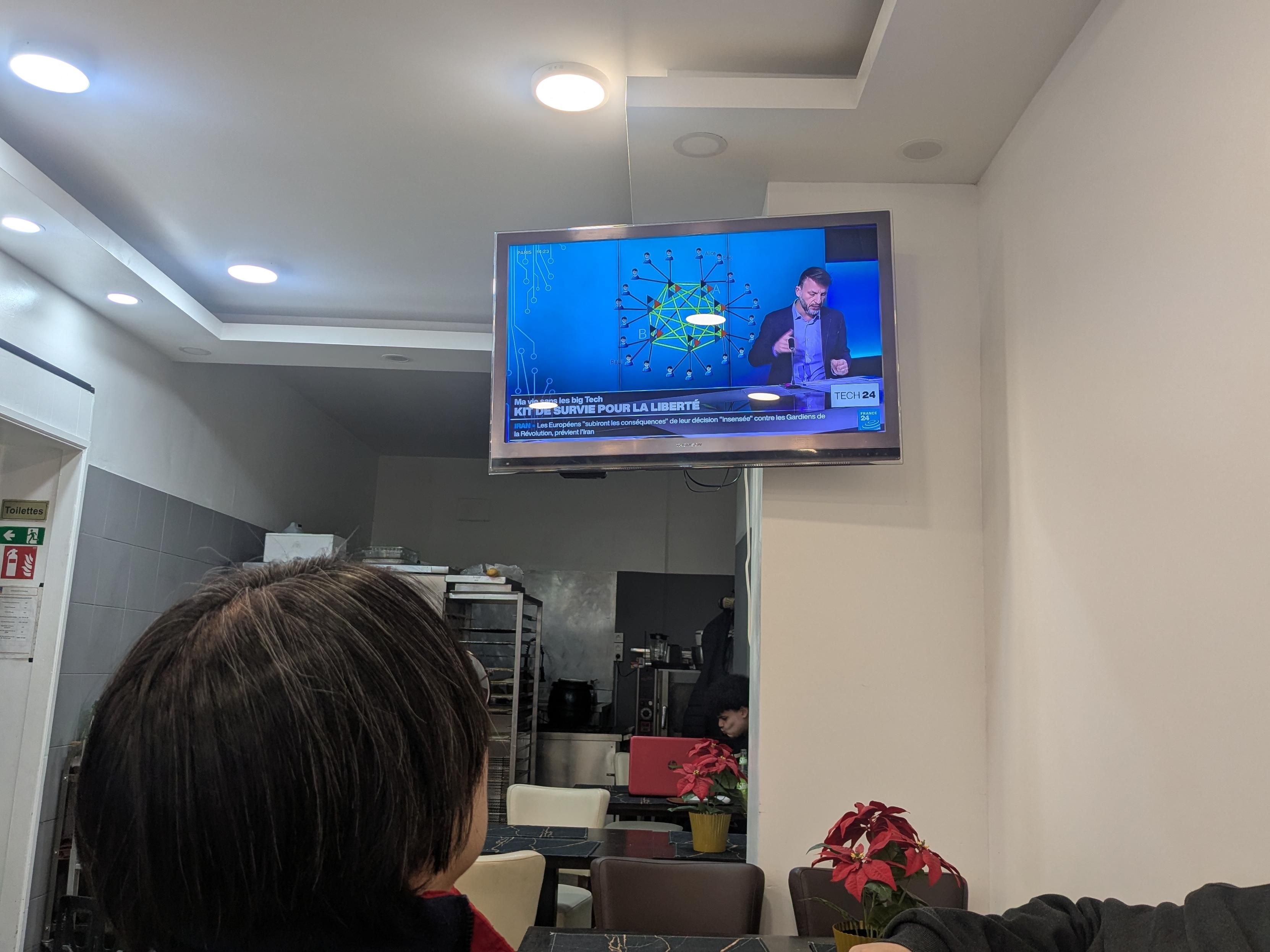 Hong looking at a tv