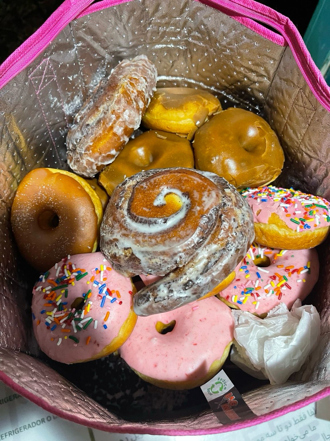 Closeup of a bag full of, I dunno... a hundred? donuts. All different types. 