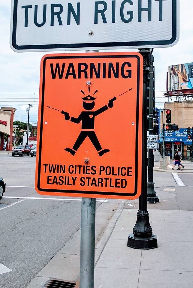 A sign reading "WARNING TWIN CITIES POLICE EASILY STARTLED"

It has a picture of a startled police officer who is firing two pistols wildly into the air.
