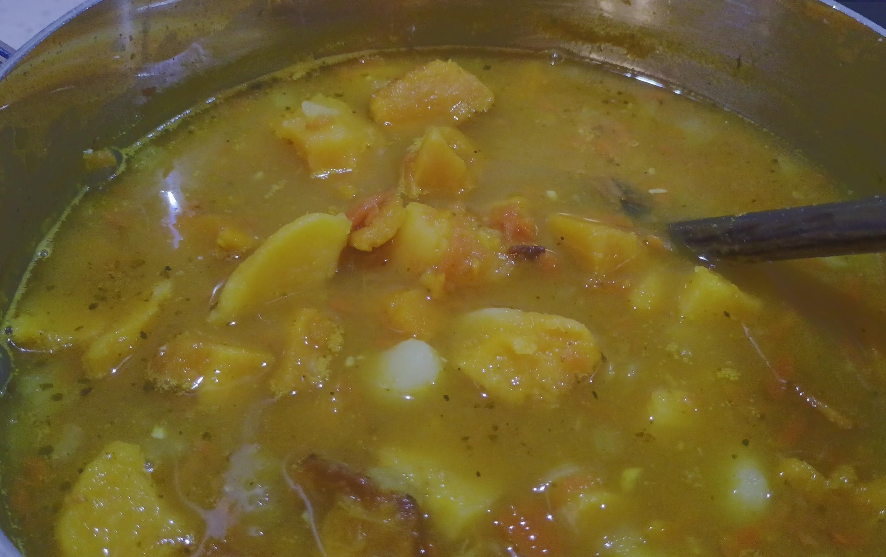 A pot of lumps of two kinds of squash (butternut and buttercup) plus herbs, spices, potatoes, carrot, onion and garlic.
