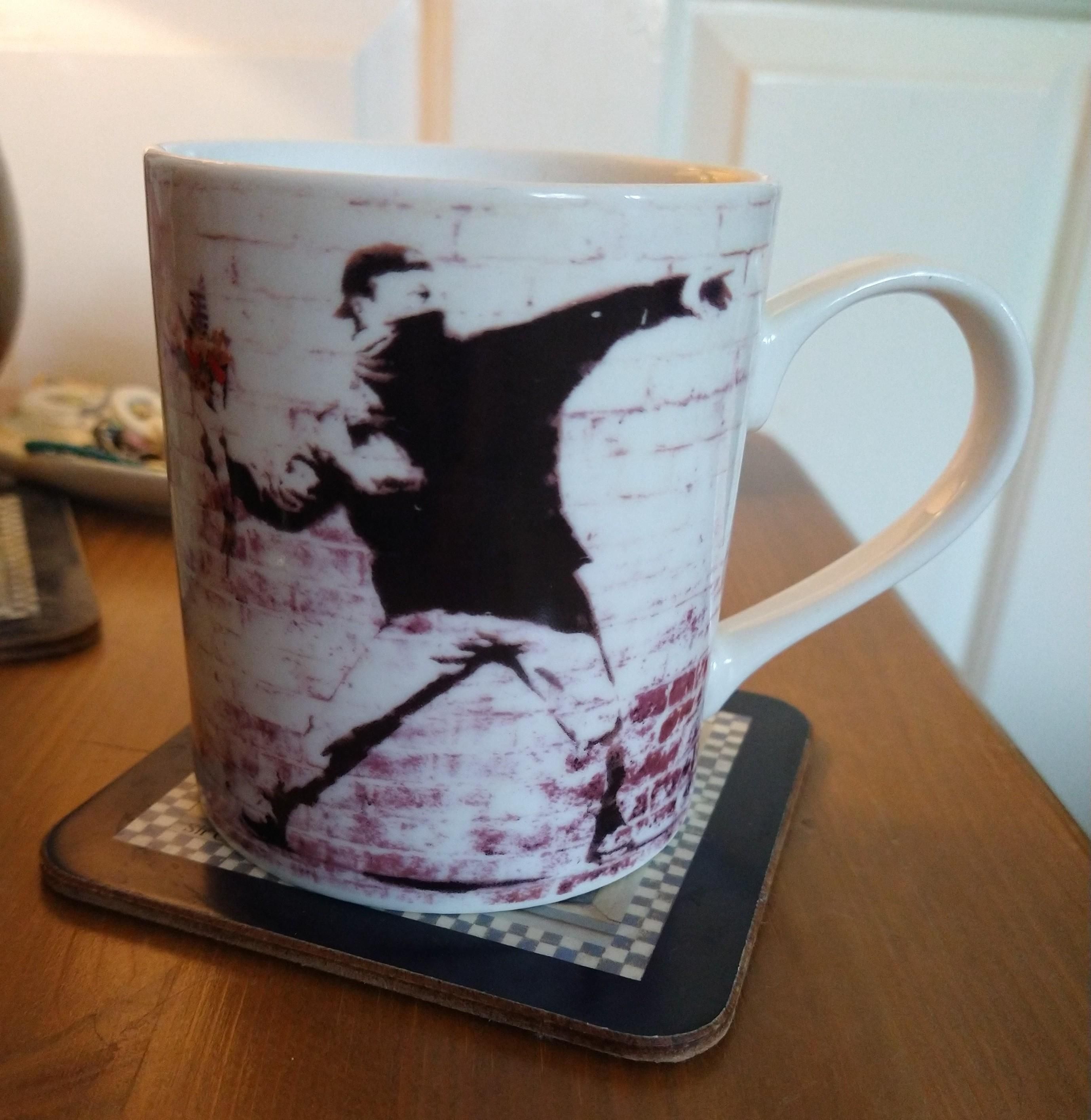 Banksky mug of tea on a bedside cabinet 