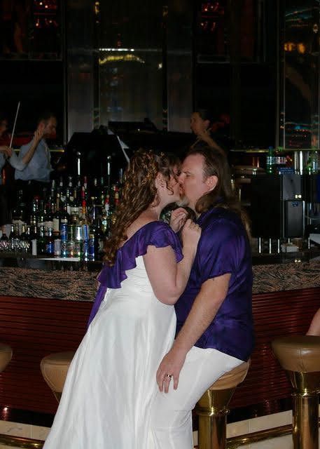 Proof that in the end, we really did get married :-)

A couple, both wearing purple and white, kissing in front of a bar. He's seated on a bar stool and she's leaning into him.

There's a string quartet in the background (they were unrelated to our wedding, but nice to hear anyway!)