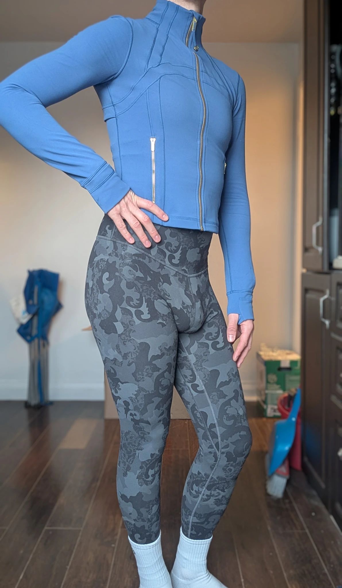 Wearing tight multi-grey leggings and a blue fitted cropped jacket, conservatively zipped up to my neck. I intend to hide nothing. My hand is on my hip and put my weight on my right leg, showing off my little bum. My other hand gently rests on my covered but unhidden thigh. 
My outfit says "look at me. Admire my body. Take in every curve."
Let the dirty thoughts flow
