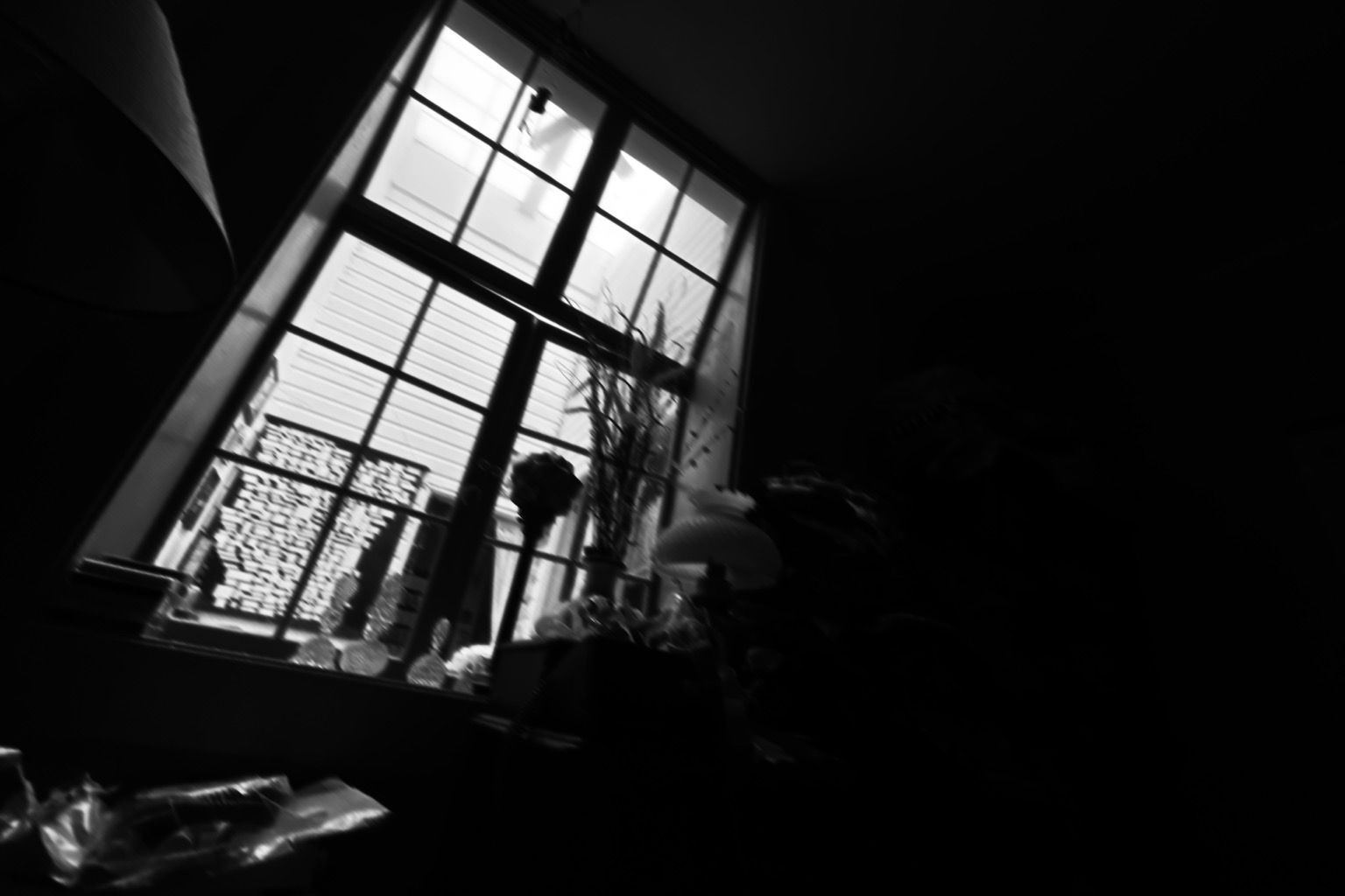 b&w, wide angle of an internal window from a dark room toward a lighted room