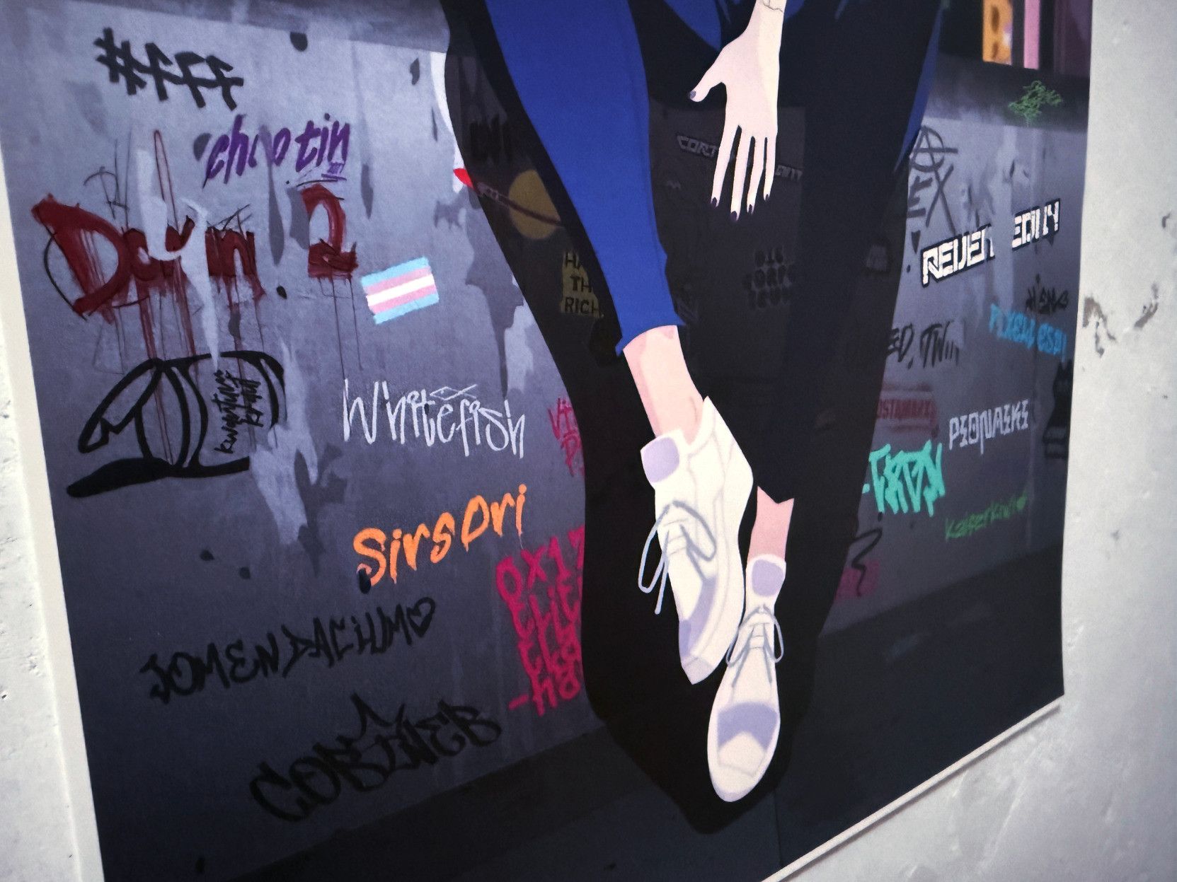 The image shows a poster with graffiti on a wall and a drawing of a person sitting. The focus is on the person's lower legs and feet, wearing white sneakers. Graffiti includes various colorful words and designs.