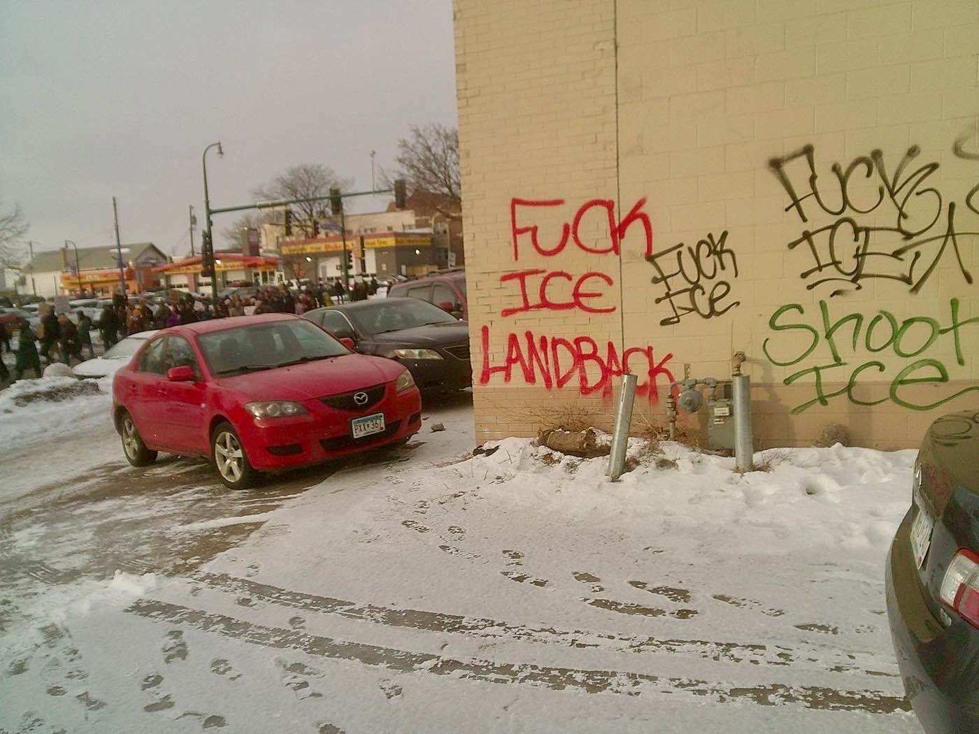 Graffiti reads "Fuck ICE Land back" and "Shoot ICE"