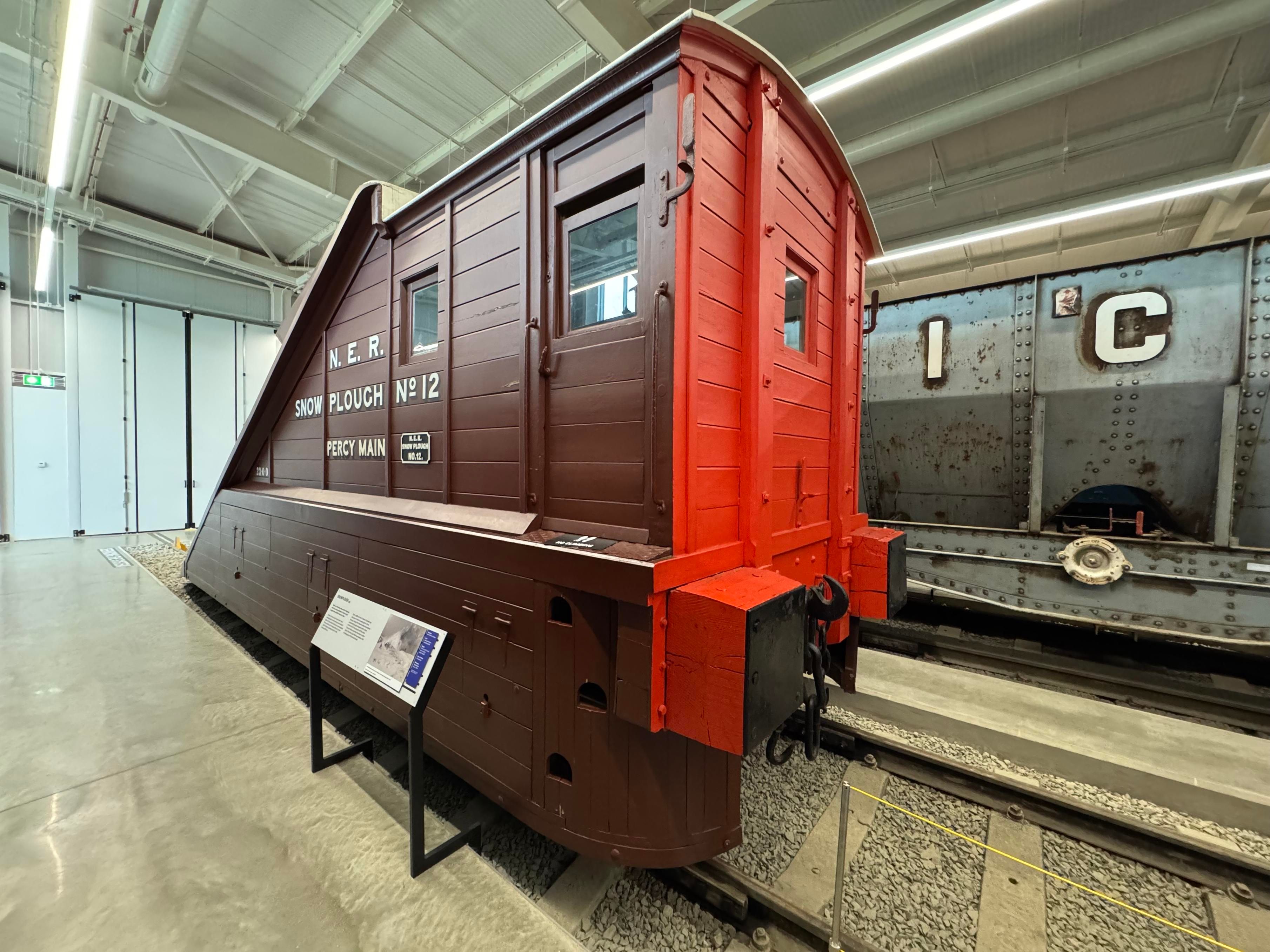3/4 rear view of the same snowplough, with a red painted rear.