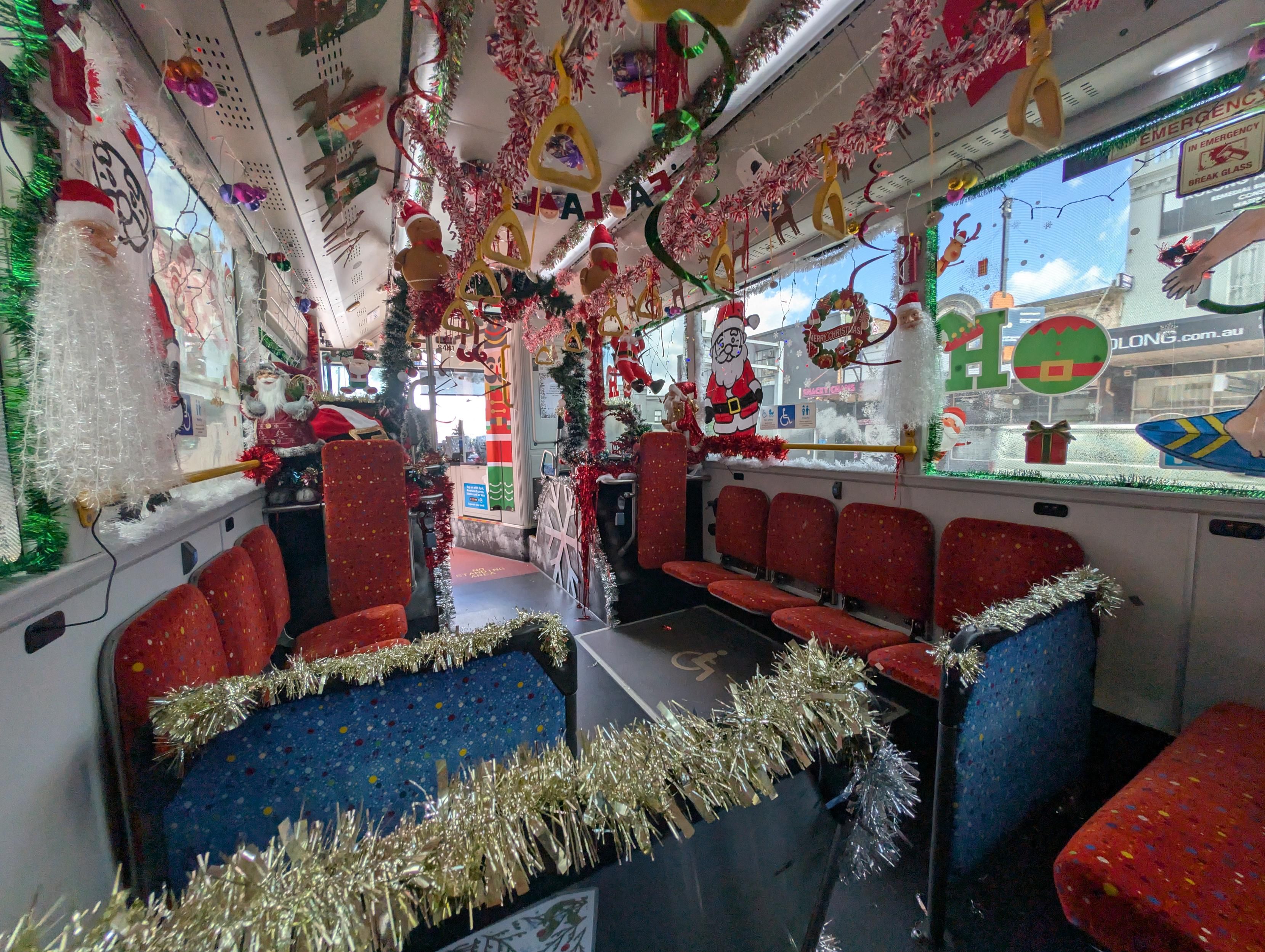 Inside a bus with a large amount of Christmas decorations