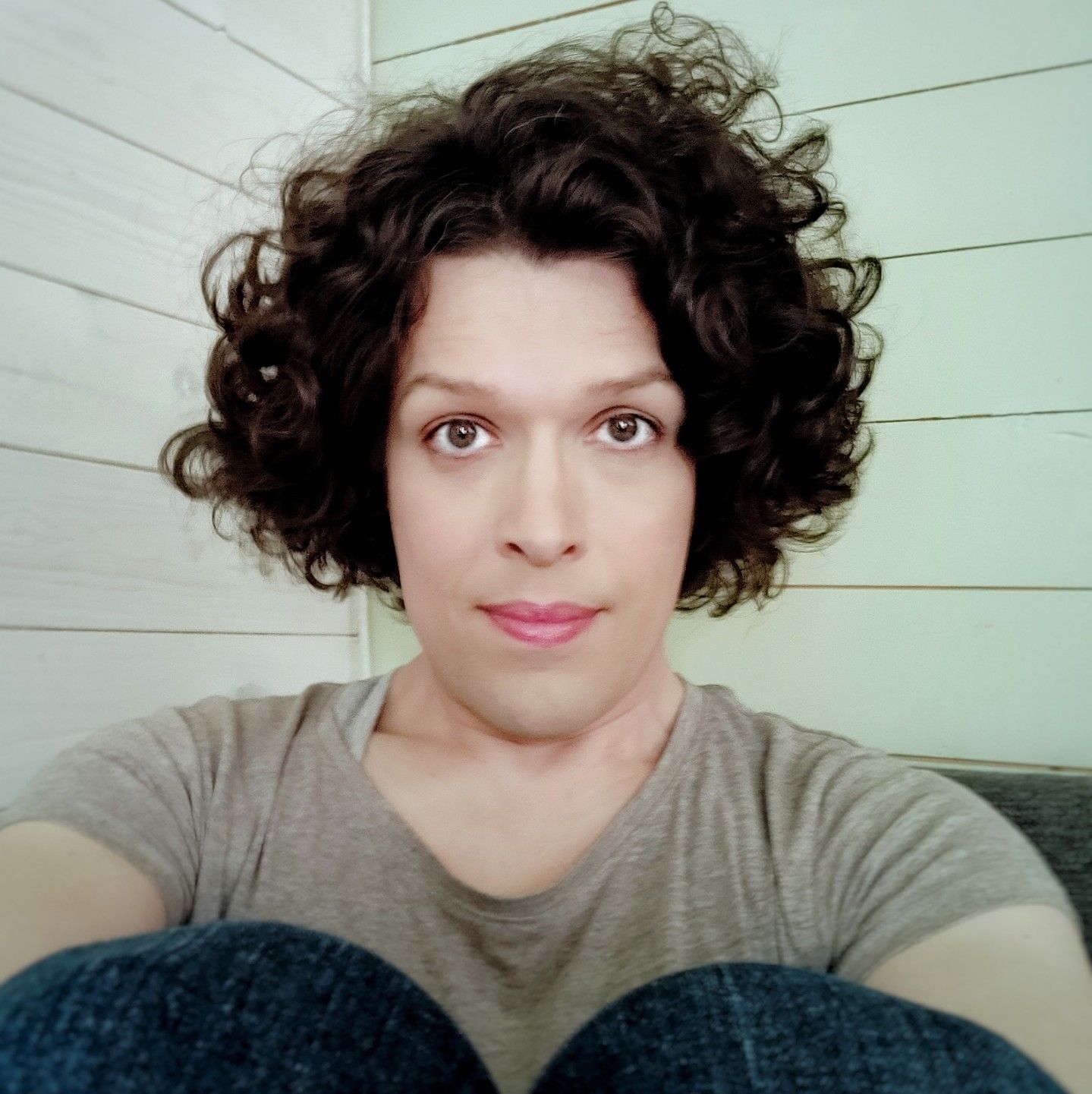 Selfie sitting, knees in front of me, looking into camera.