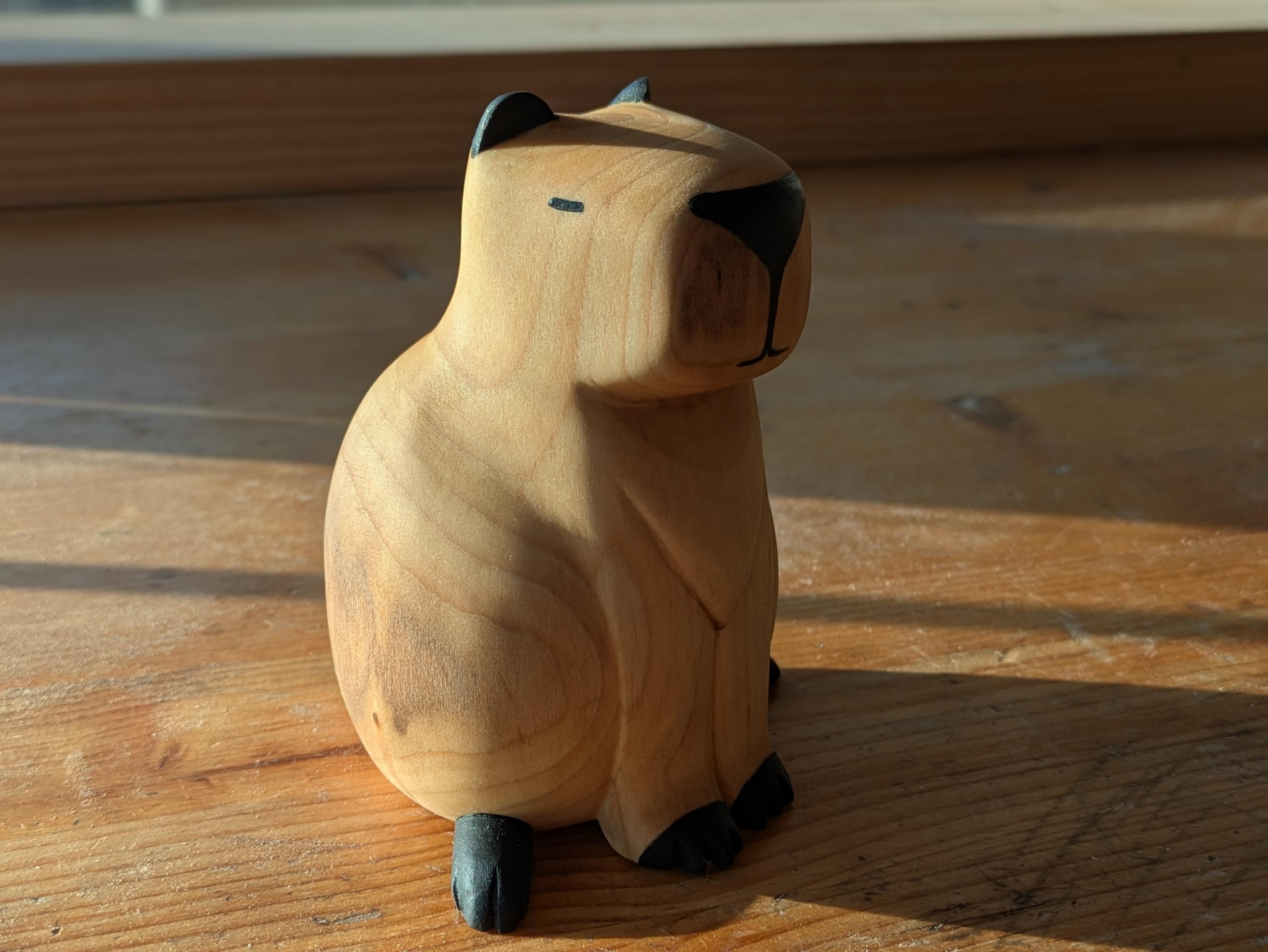 Woodcarved capybara on a workbench