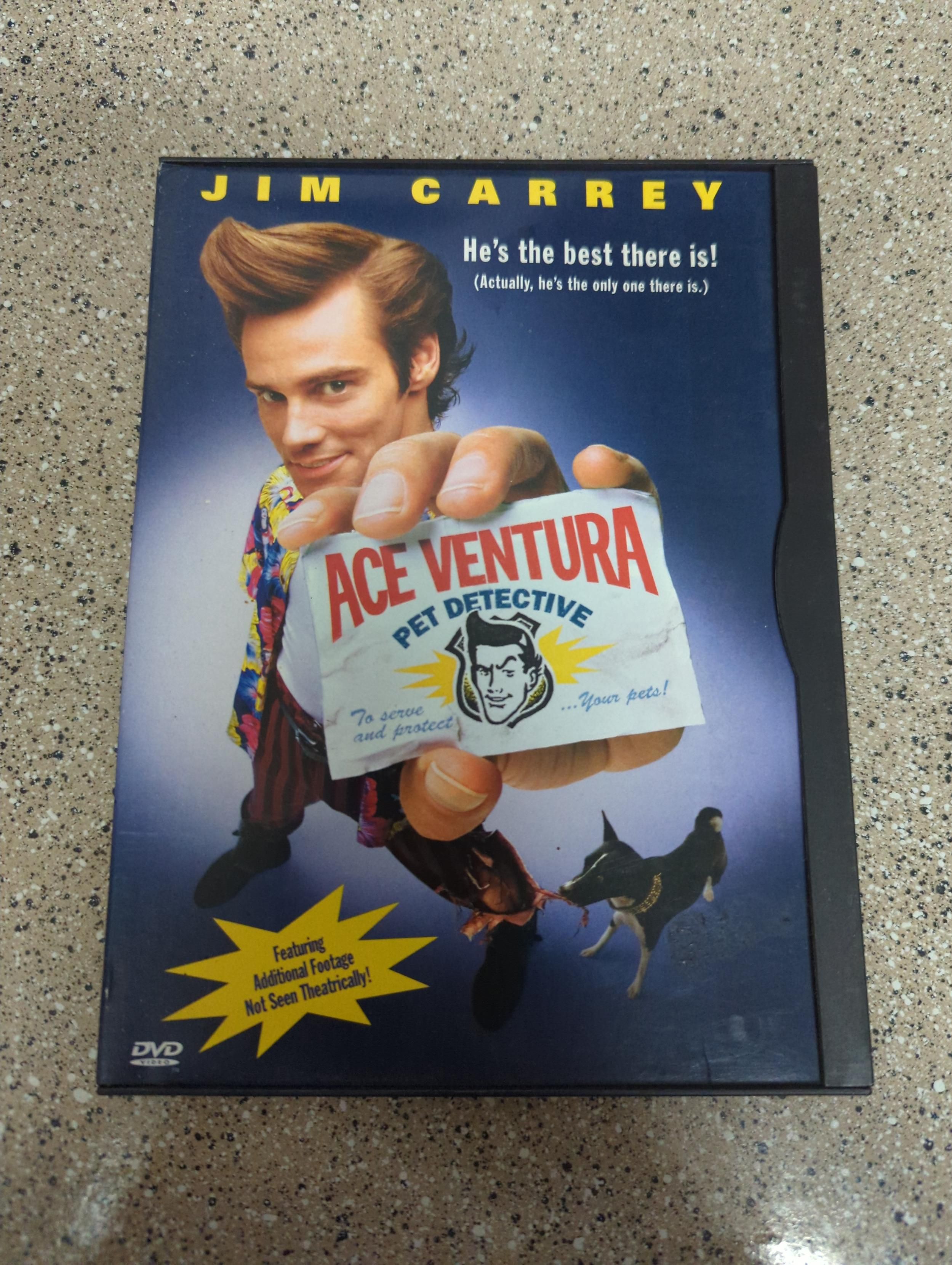 DVD case of Ace Ventura, with Jim Carrey standing next to a dog and holding his business card up to the camera.
