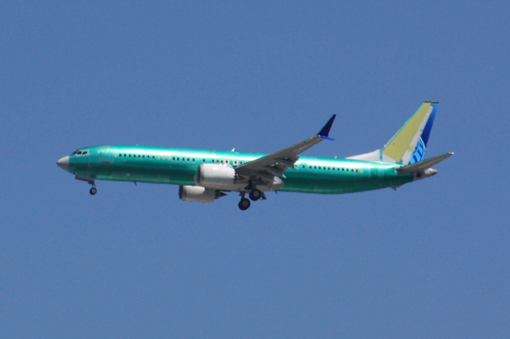 Boeing 737 Max9 on final approach to Portland Int'l Airport PDX. The plane is unpainted, covered in a green vinyl protective coating which will be removed at the paint hangar. The pre-painted rudder and winglets indicate this aircraft's customer is United Airlines. Photo taken from my backyard with optical zoom at a distance of about 1 mile. The only processing was to crop the photo.
photo by Ian Kluft
July 22, 2025
Portland, Oregon, USA